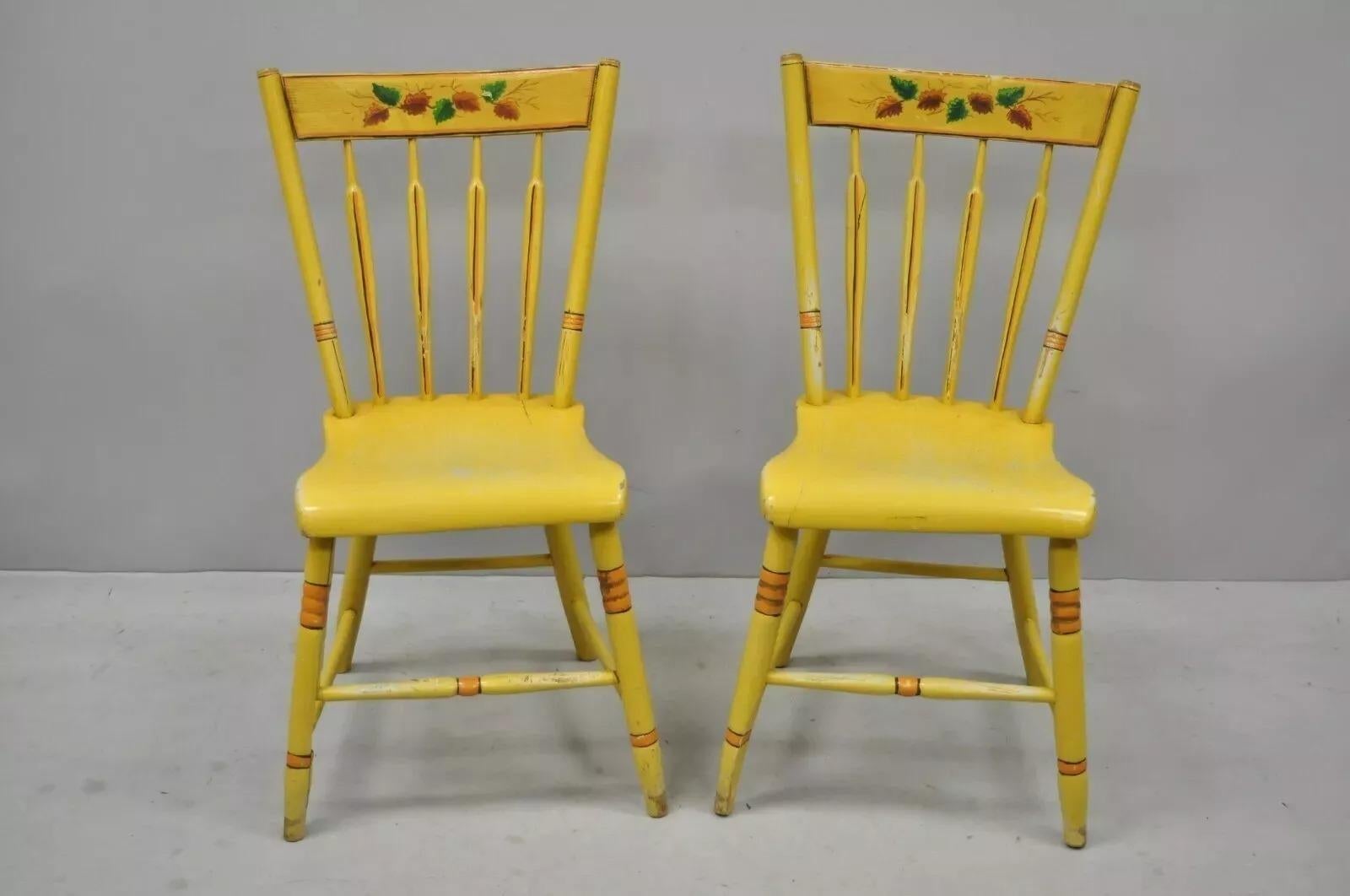 Antique Windsor Hitchcock Style Yellow Painted Plank Seat Side Chairs - a Pair. Item features distress painted frames, plank seats, spindle backs, solid wood construction, very nice antique item, quality American craftsmanship. Circa Early 20th