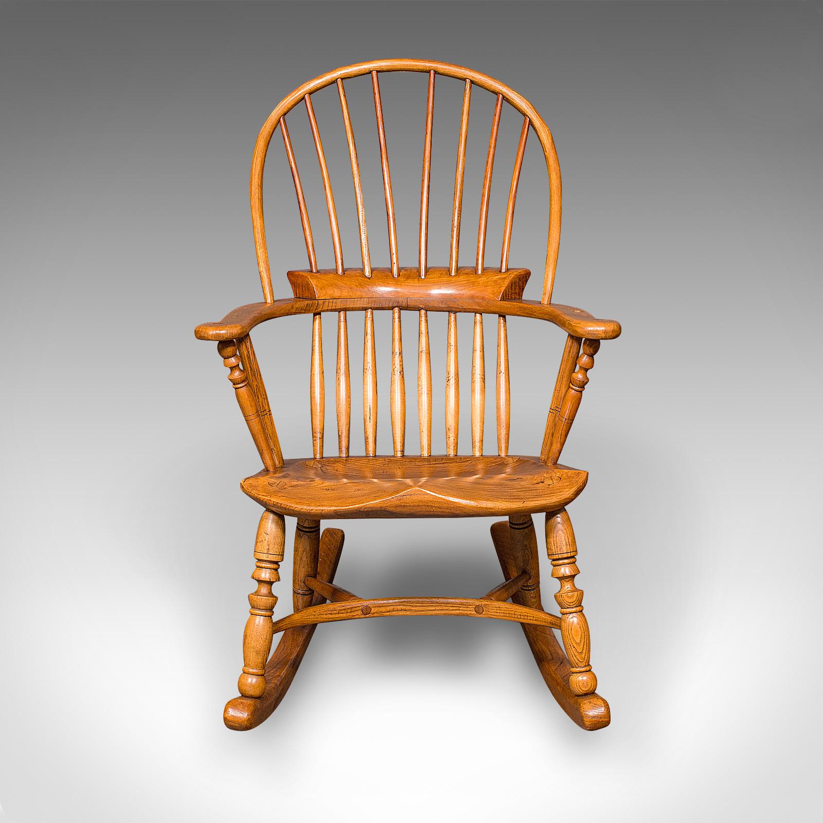 This is an antique Windsor rocking chair, an English, elm and ash porch or fireside rocker, dating to the late Victorian period, circa 1900.

Traditionally appealing form with a gentle, smooth rocking motion
Crafted in a combination of elm and ash,