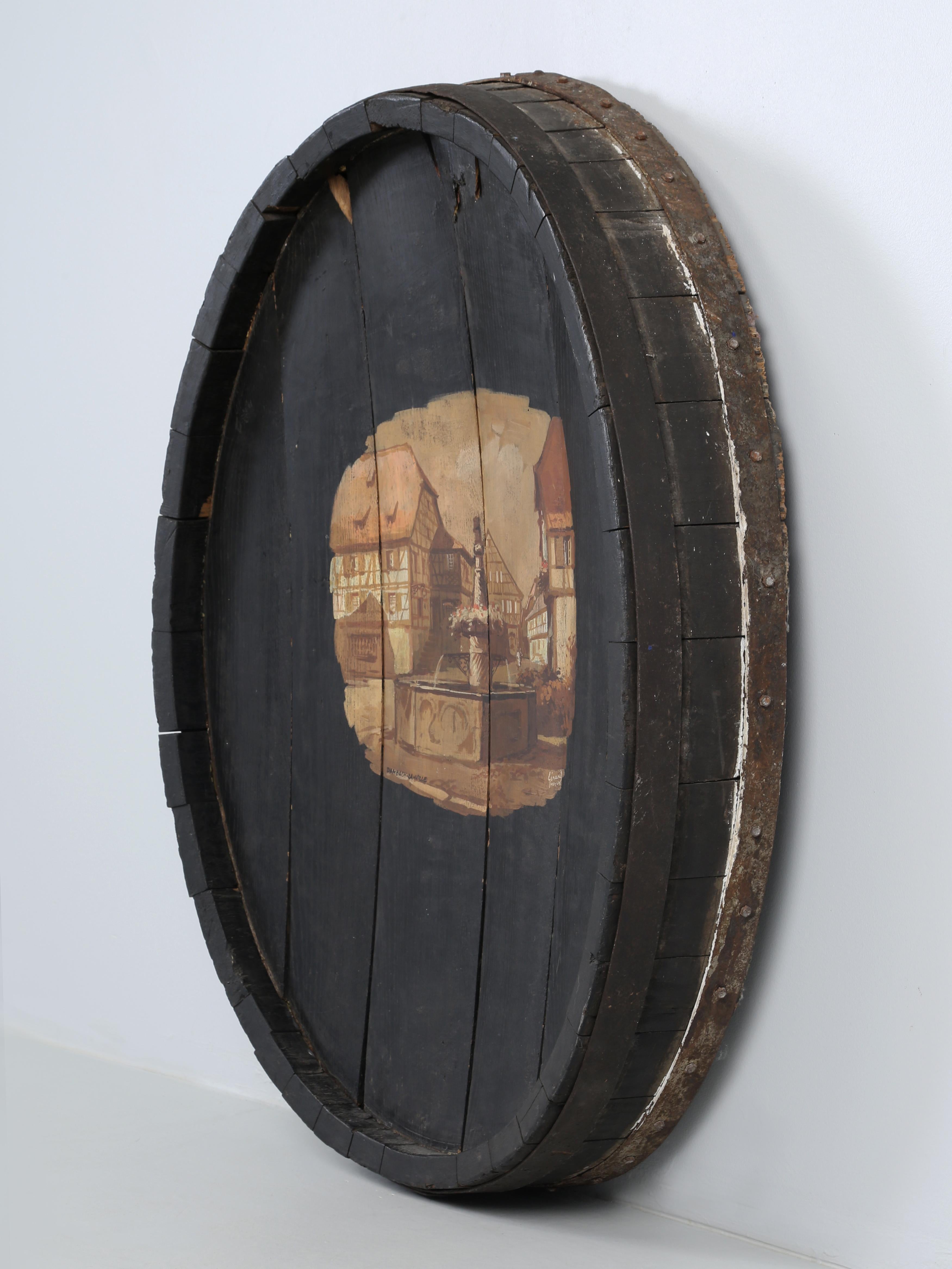 Antique Wine Barrel End Repurposed as Wall Art with a beautifully executed painting of Dambach-la-ville, France. Dambach-la-Ville is a small area in the Alsace Region in North-East France. Dambach-la-Ville is known for its high- quality wines and we