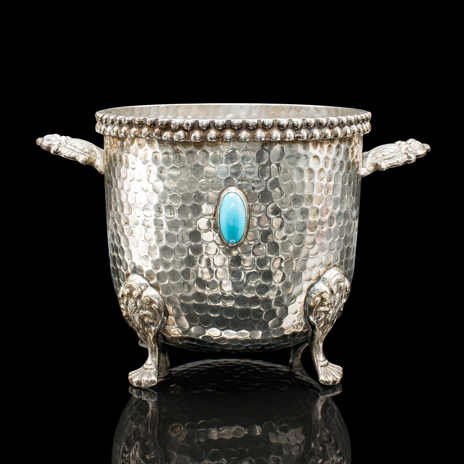 
This is an antique wine bottle cooler. A German, Alpaca nickel silver plated champagne magnum bucket, dating to the early 20th century, circa 1920.

Fascinating example with Arts & Crafts overtones
Displays a desirable aged patina and in good