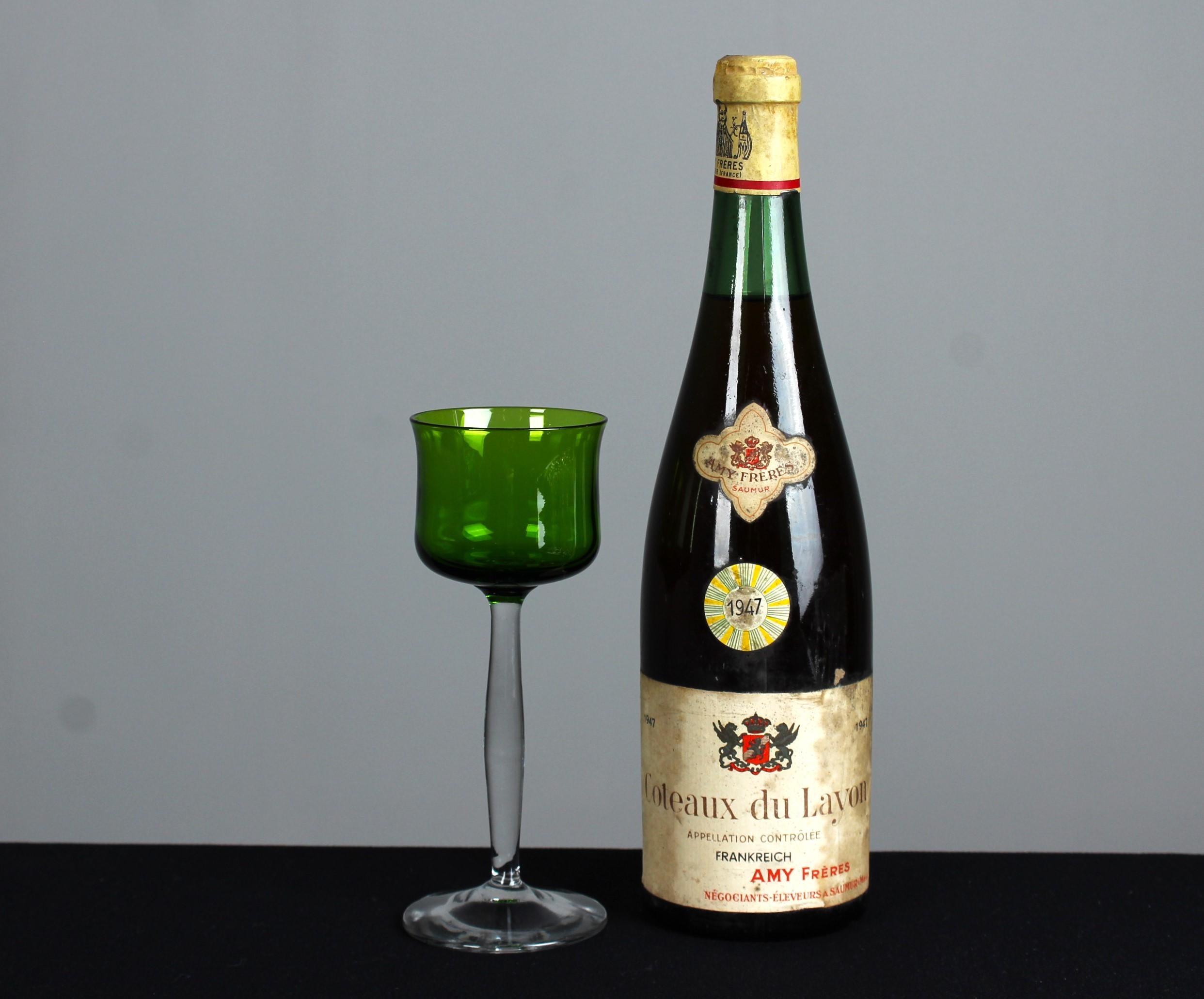 A beautiful antique, green coloured wine glass.

At the turn of the 20th century, the French culture of fine dining and socialising flourished, leading to the emergence of a symbol of French epicurean culture: the aperitif glass. These glasses not