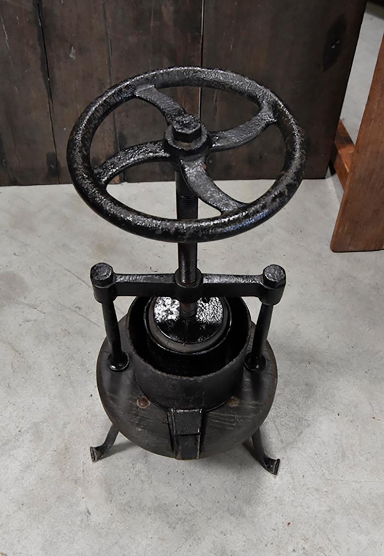 antique wine press with cast iron base
