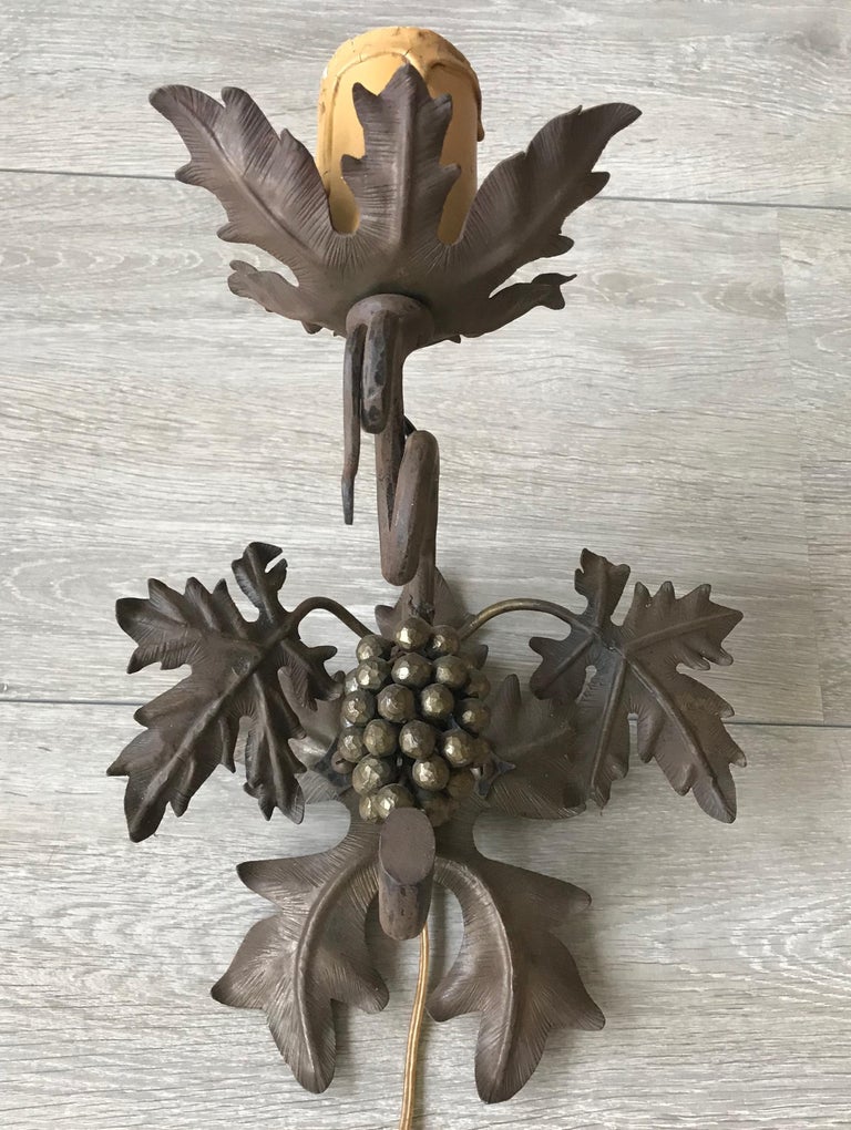 Unique Arts & Crafts work of lighting art.

If you are looking for a unique and elegant wall sconce to grace a special space then this handcrafted fixture could be perfect for you. This one of a kind design is all-handcrafted out of wrought iron