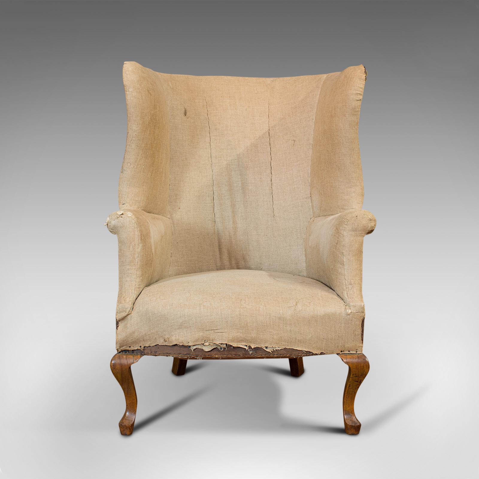 This is an antique wing armchair. An English, barrel-back seat, dating to the late Victorian period, circa 1900.

Presented ready for its final reupholstering
Displaying a wonderfully patinated appearance
Striking barrel-back with high wing
