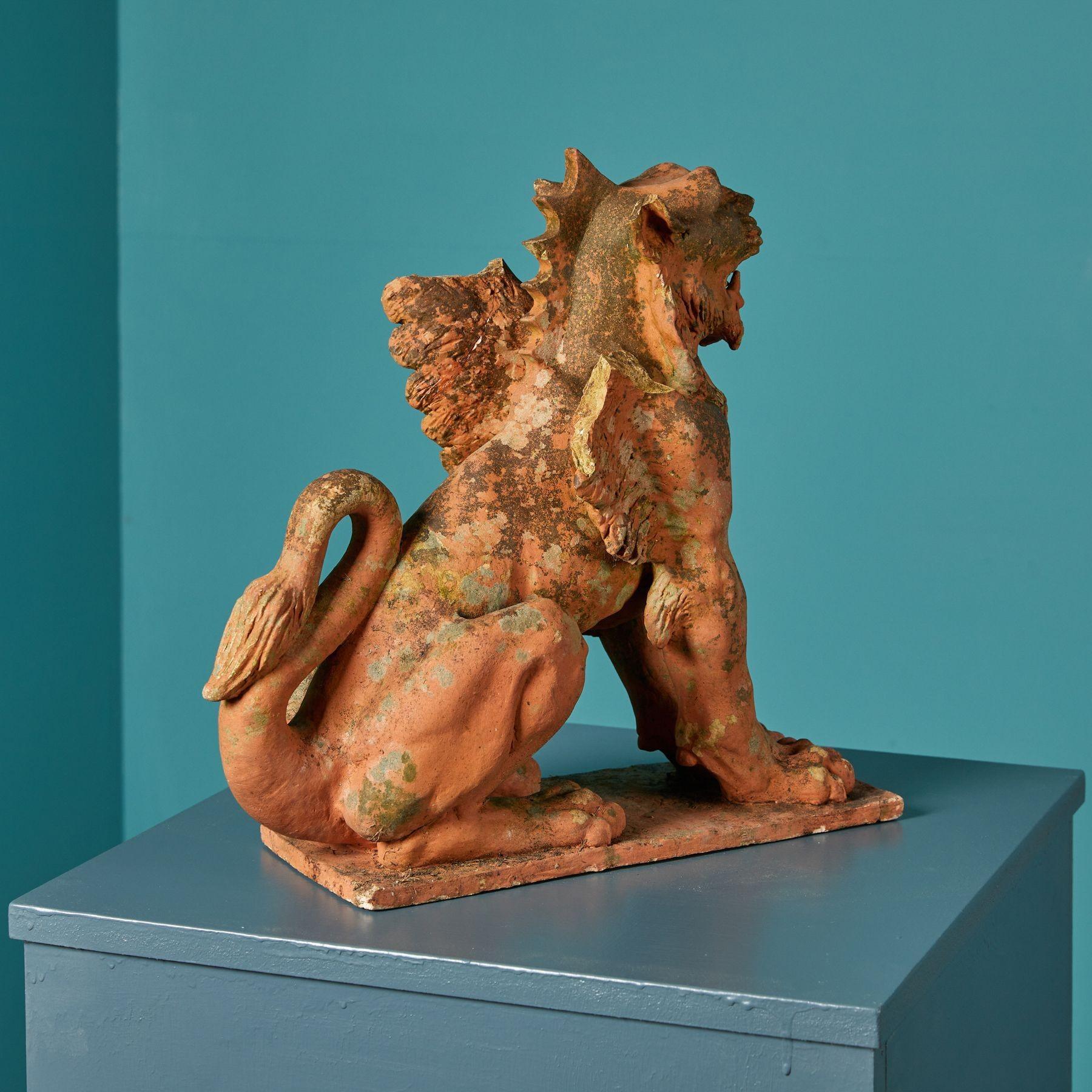 Resembling a mythical creature of folklore, this winged lion statue is an object of interest and historical intrigue. Despite losses to the wings and one ear, details of the lion crafted in terracotta more than 100 years ago are beautifully