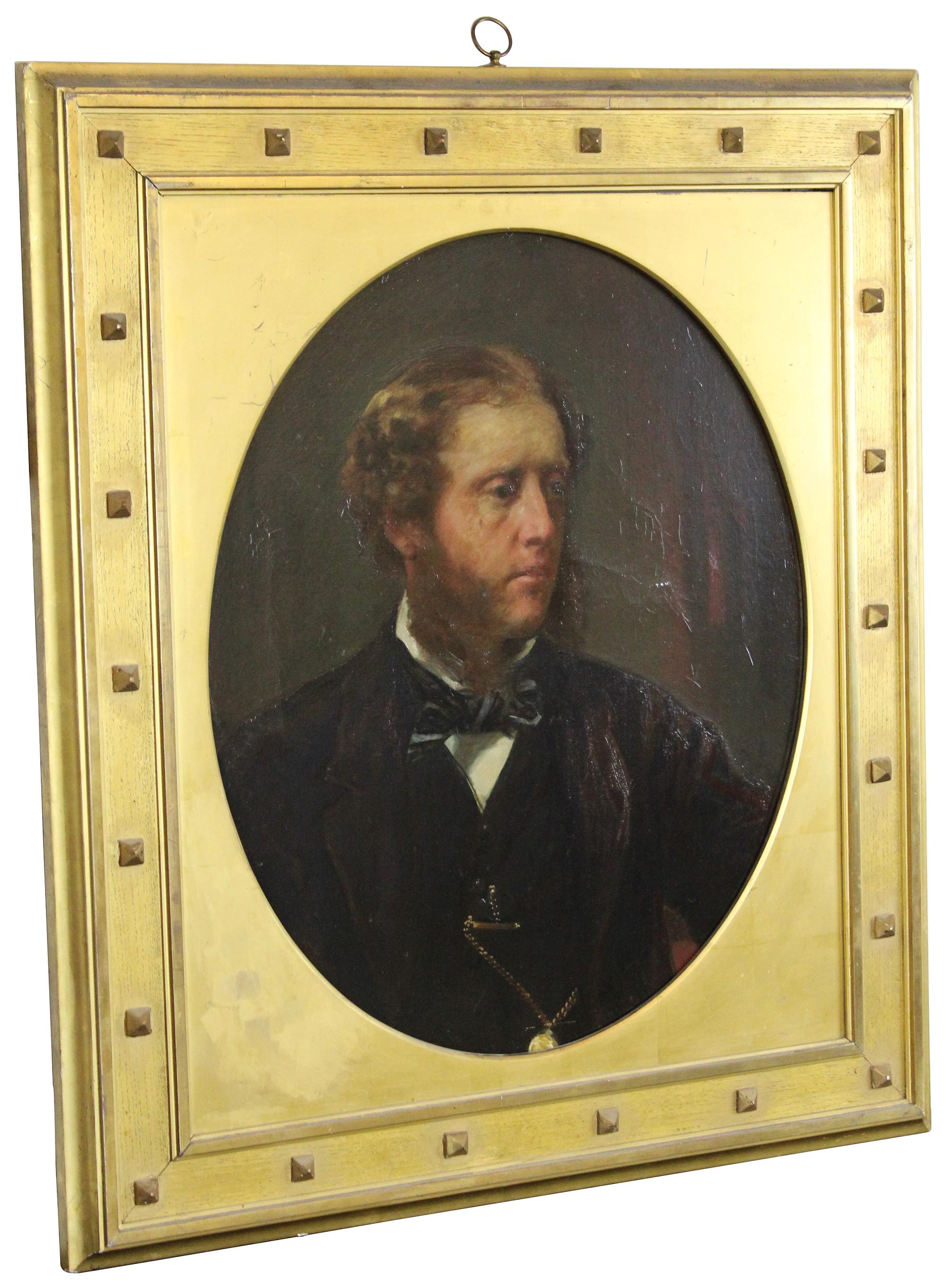 Antique 19th century portrait oil painting prepared by Winsor Newton. Features a young man dressed in traditional attire with big sideburns, a bowtie and pocket watch. Finished with a gothic inspired gold gilt oval encased frame with rivets.