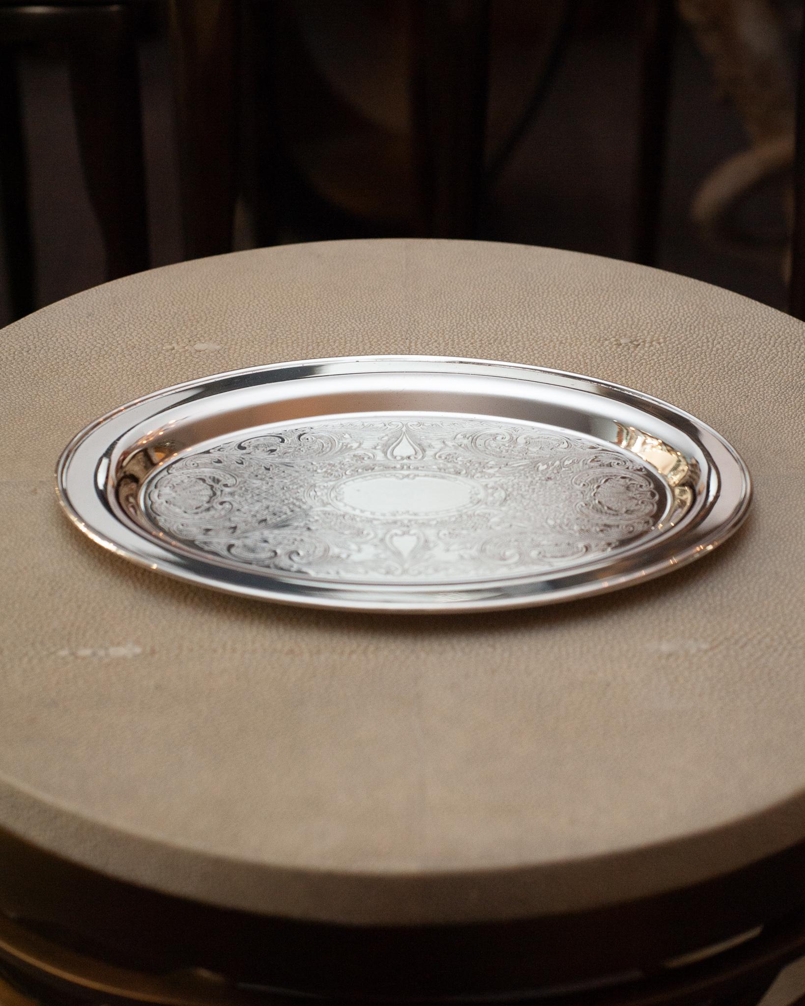 An antique small WM A Rogers silver plate oval serving tray with engraved interior. Silver plated copper.