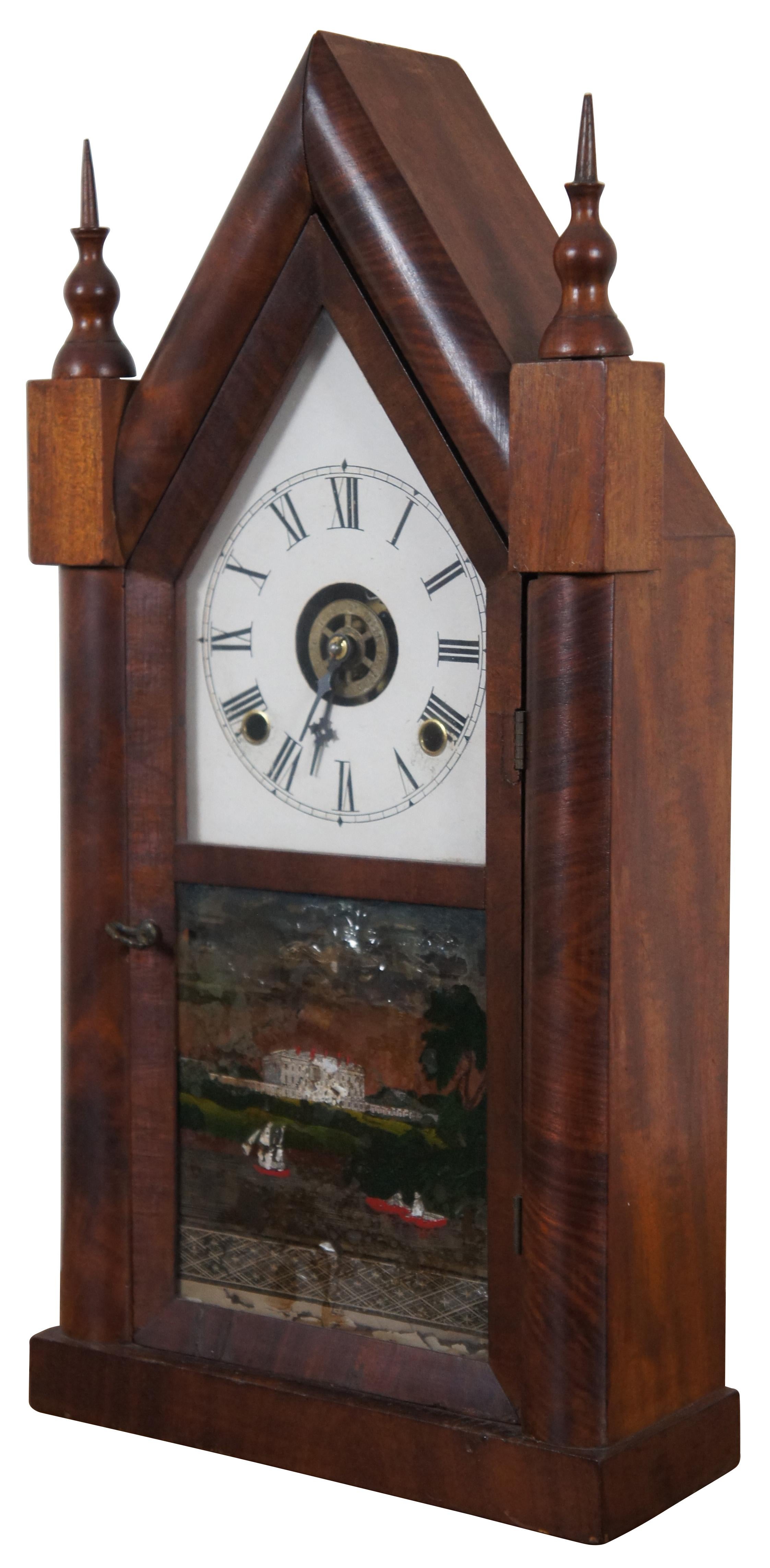 Antique 19th century mahogany cathedral / steeple Gothic Revival mantel clock by William L Gilbert Clock Company, with Roman numeral face and reverse painted scene on the door that features a large estate / castle / palace overlooking a body of