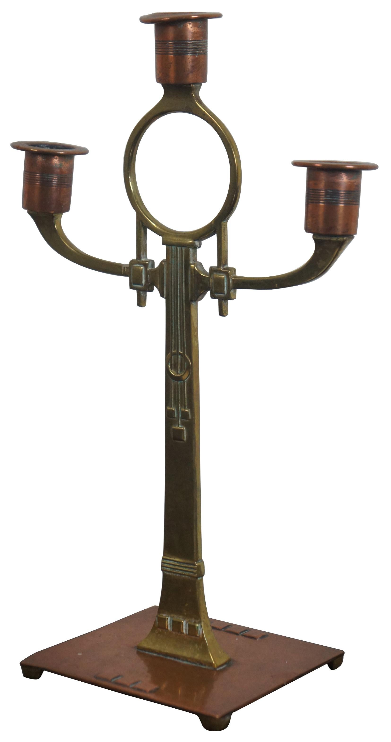 WMF Jugendstil style copper and brass candlestick with Osterich mark. A very stylish secessionist design from the Aesthetic period in Germany. Made by Wurttembergische Metallwarenfabrik circa 1880s-1920s.