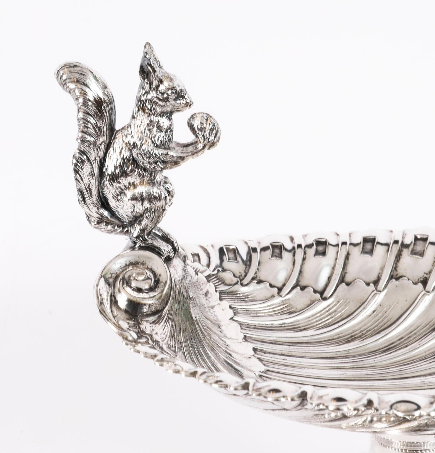 This is a fine good size, high quality.  WMF antique silver-plated nut dish or sweet dish, marked Wurttembergische Metallwarefabrik,  dating from the mid 19th century.

It features a fabulous shell embossed body with fluting and has a squirrel