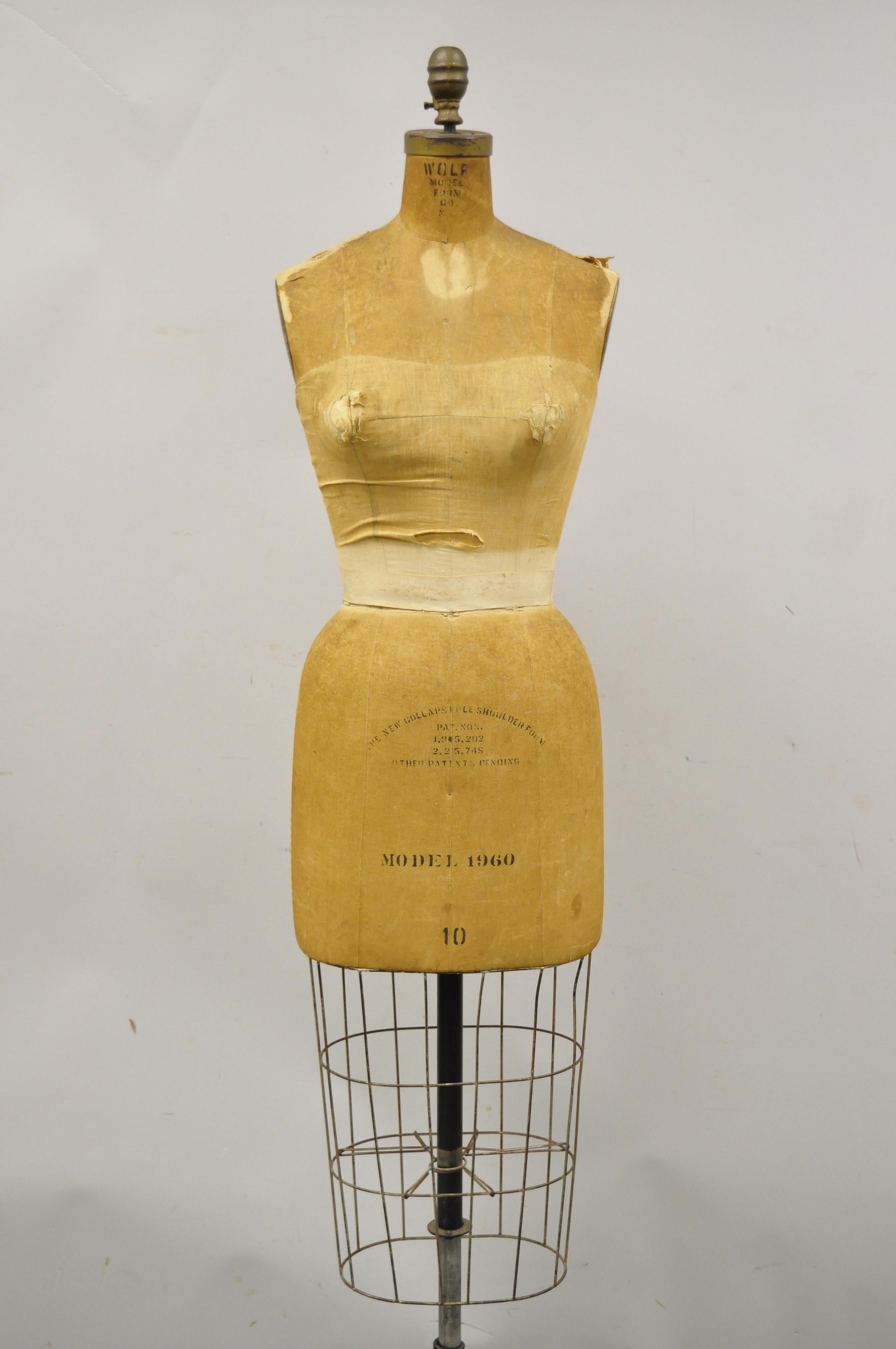 Antique Wolf Model 1960 womens cast iron cage dress form size 10. Item features collapsible shoulders, cage base, rolling casters, very nice antique item, quality American craftsmanship. Circa 1960. Measurements: 68