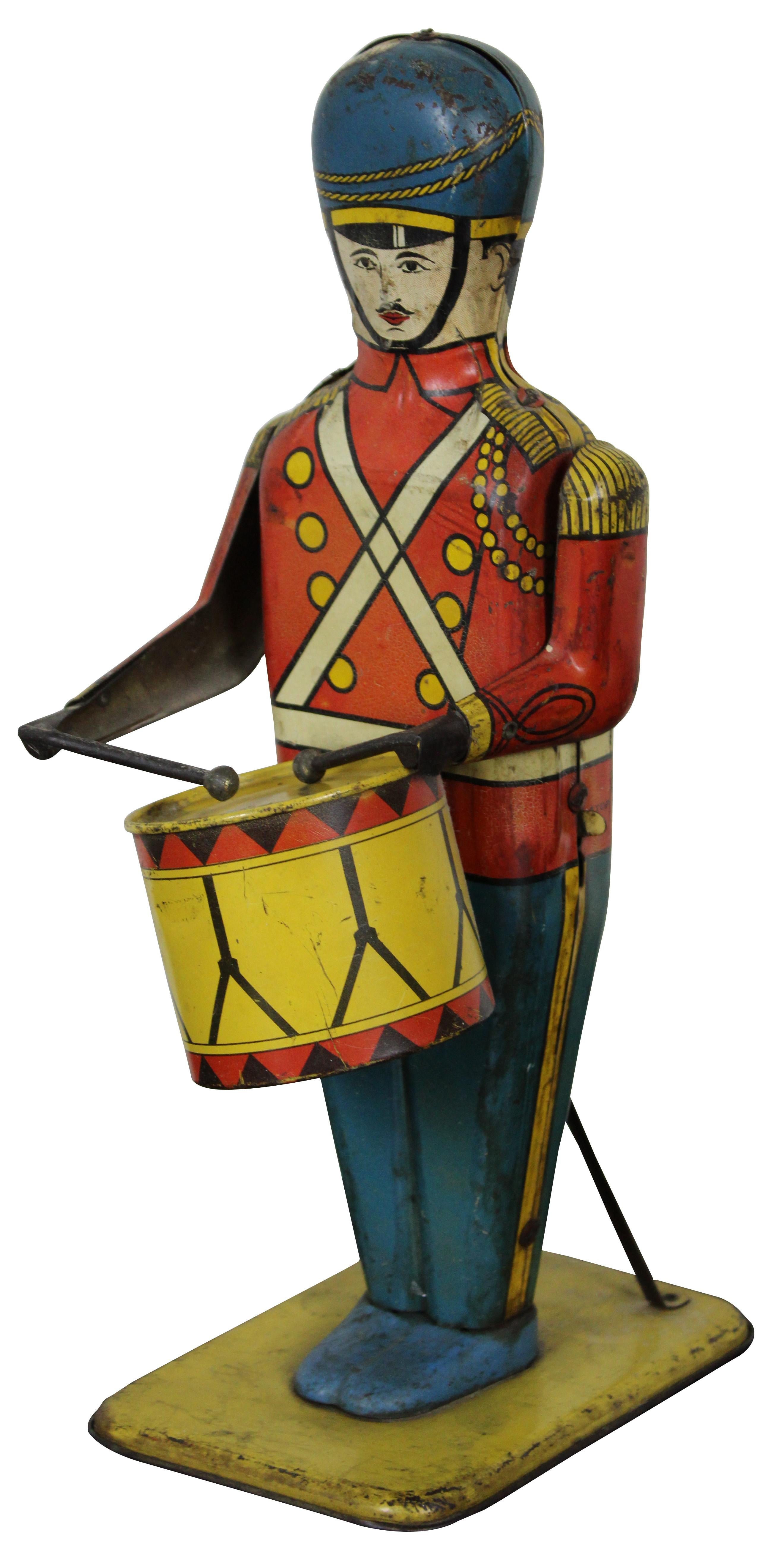 Antique 1939 lithograph tin soldier by Wolverine Supply and Manufacturing Company, No 27 Drum Major, dressed in a red coat with blue hat and pants; plays his drum when you wind the key in his back.
      