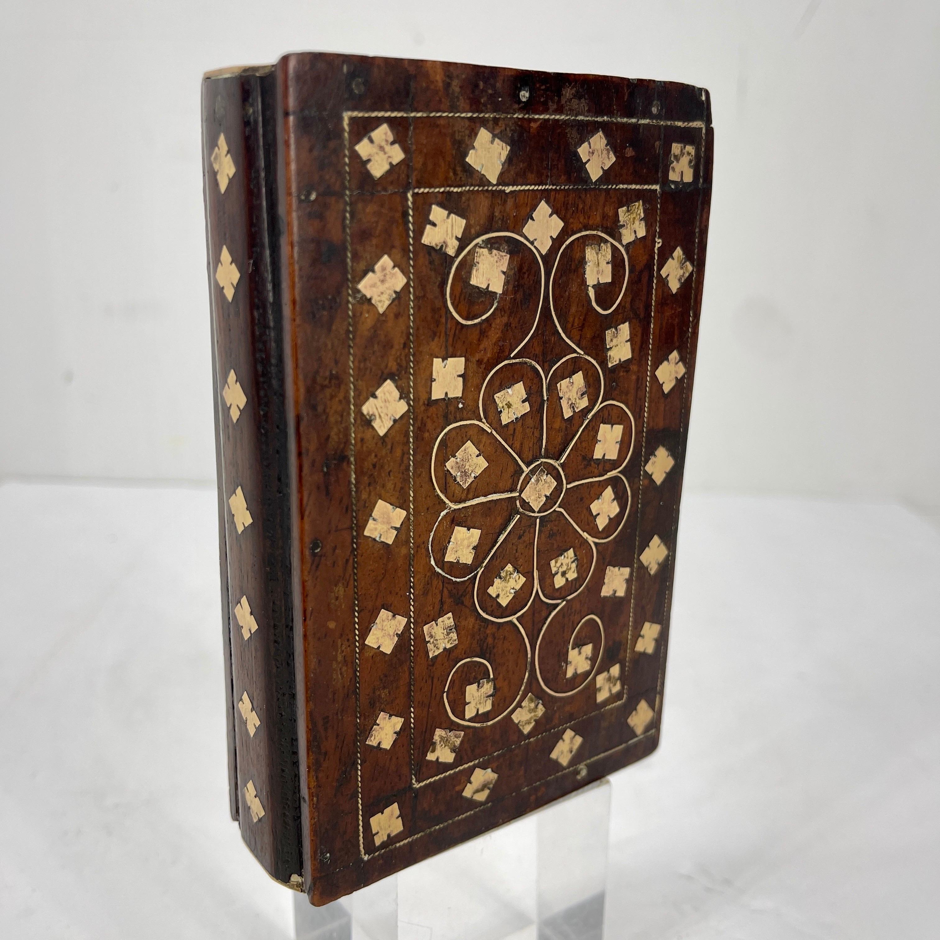 Antique wood faux book with hidden compartment. Designed to appear as a beautiful book, this wood box is the perfect place to store your treasures. The brass inlay is striking against the aged wood. The interior opens to reveal a drawer for your
