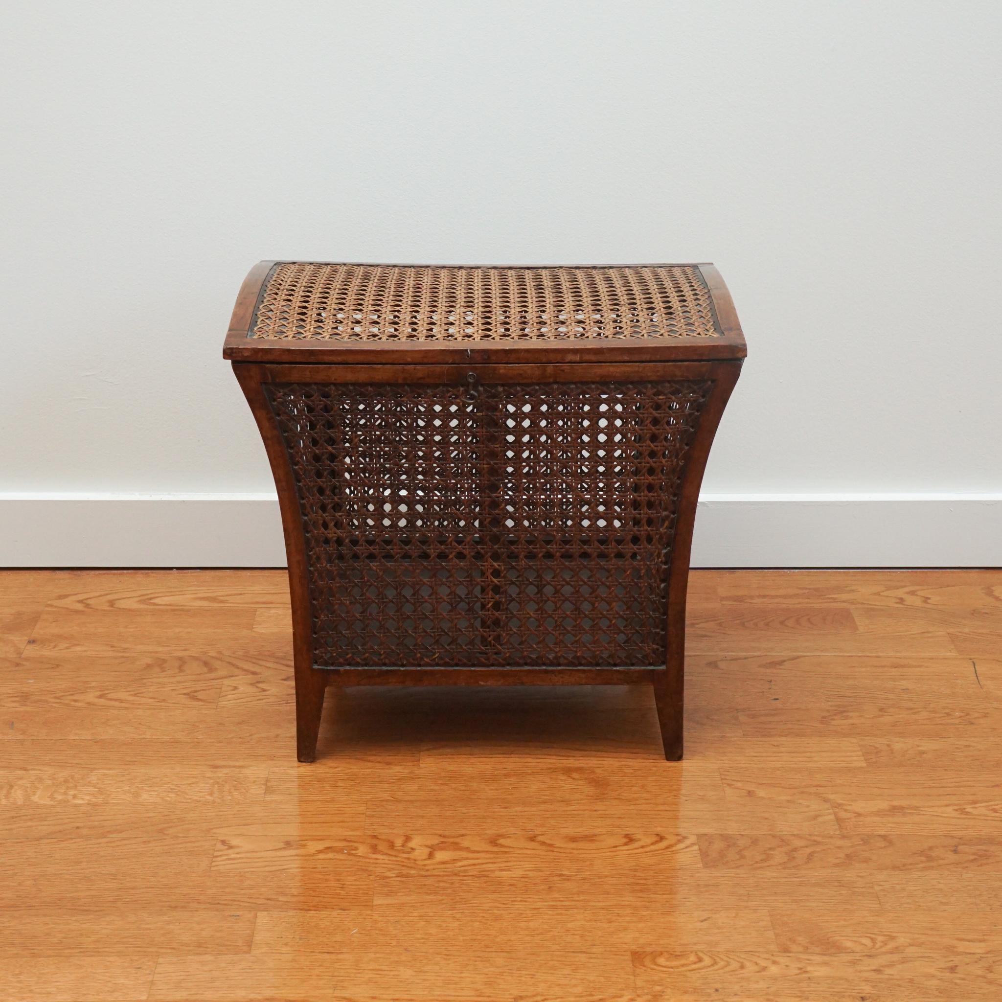Designed for practical use, this antique wood and cane hamper is as functional today as it was when first made. The hamper is in very good condition given its age (1890s) and the original caning, stitching and hinges are intact. Whether you consider