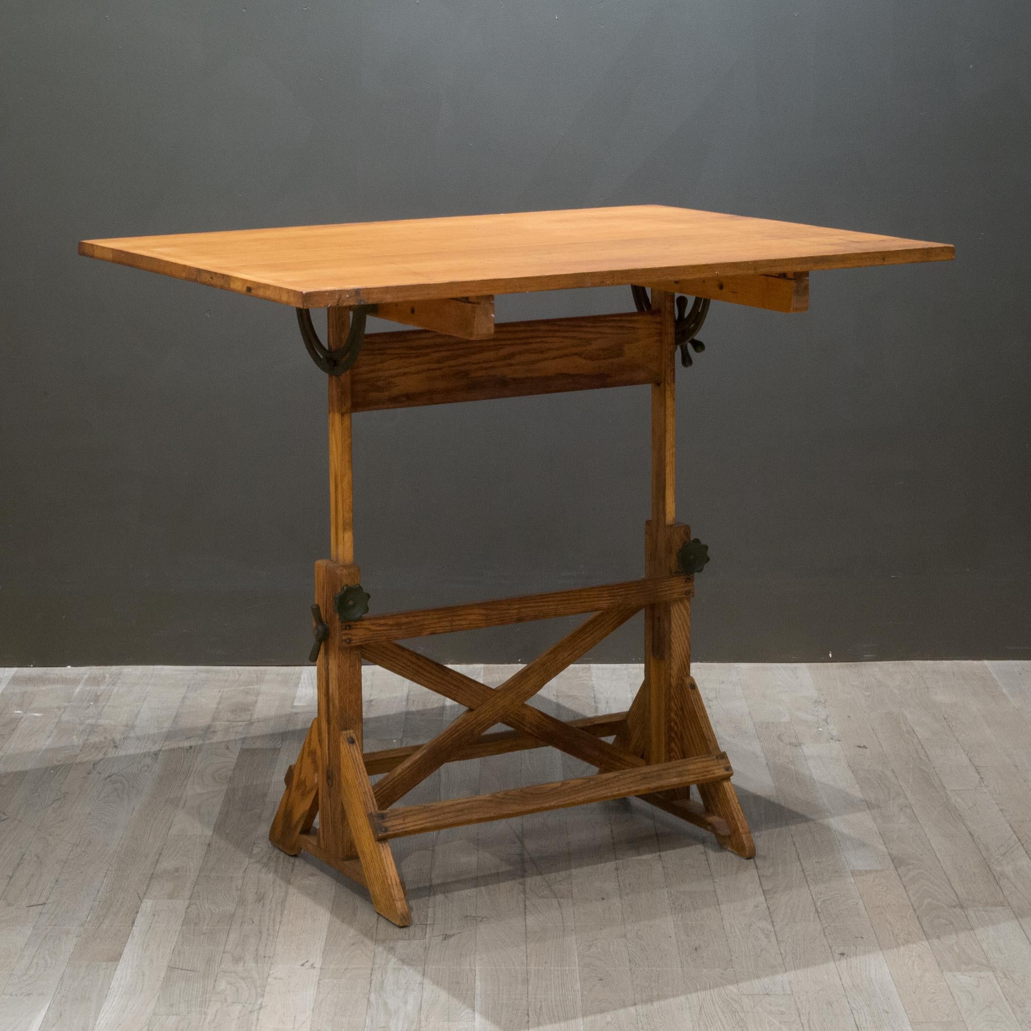About

A fully adjustable industrial wooden drafting table with green steel and cast iron knobs and brackets. The table can be used as a dining table, desk or drafting table. The top swivels at any angle and from either side. The whole table can be