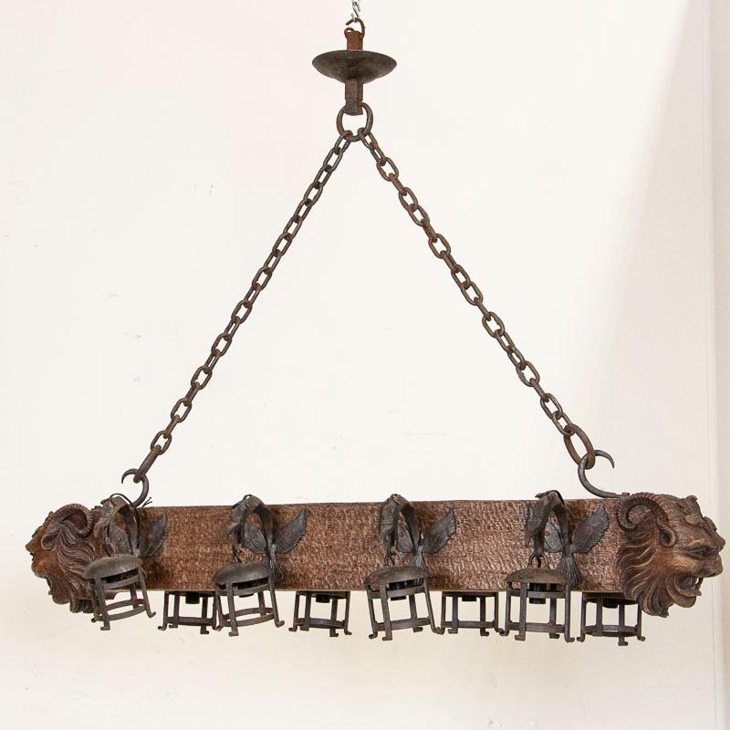 French Antique Wood and Wrought Iron Horizontal Chandelier with Carved Gargoyle Heads