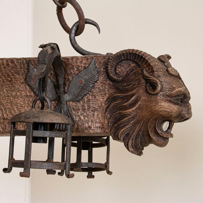Antique Wood and Wrought Iron Horizontal Chandelier with Carved Gargoyle Heads In Good Condition In Round Top, TX