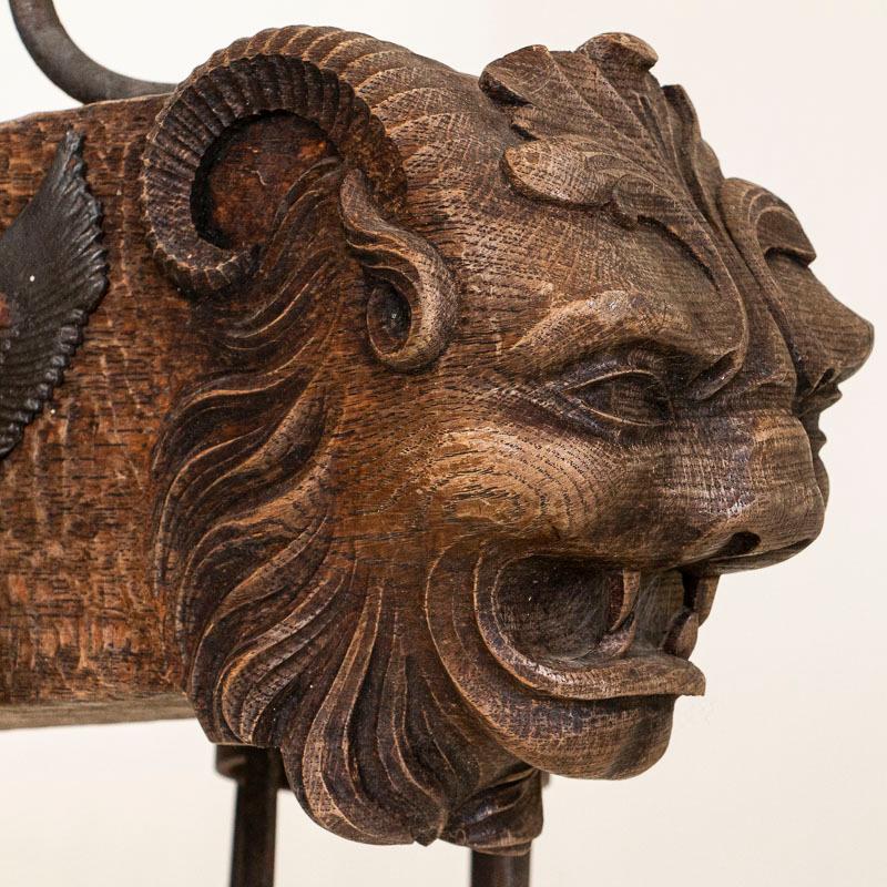 20th Century Antique Wood and Wrought Iron Horizontal Chandelier with Carved Gargoyle Heads