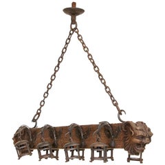 Antique Wood and Wrought Iron Horizontal Chandelier with Carved Gargoyle Heads