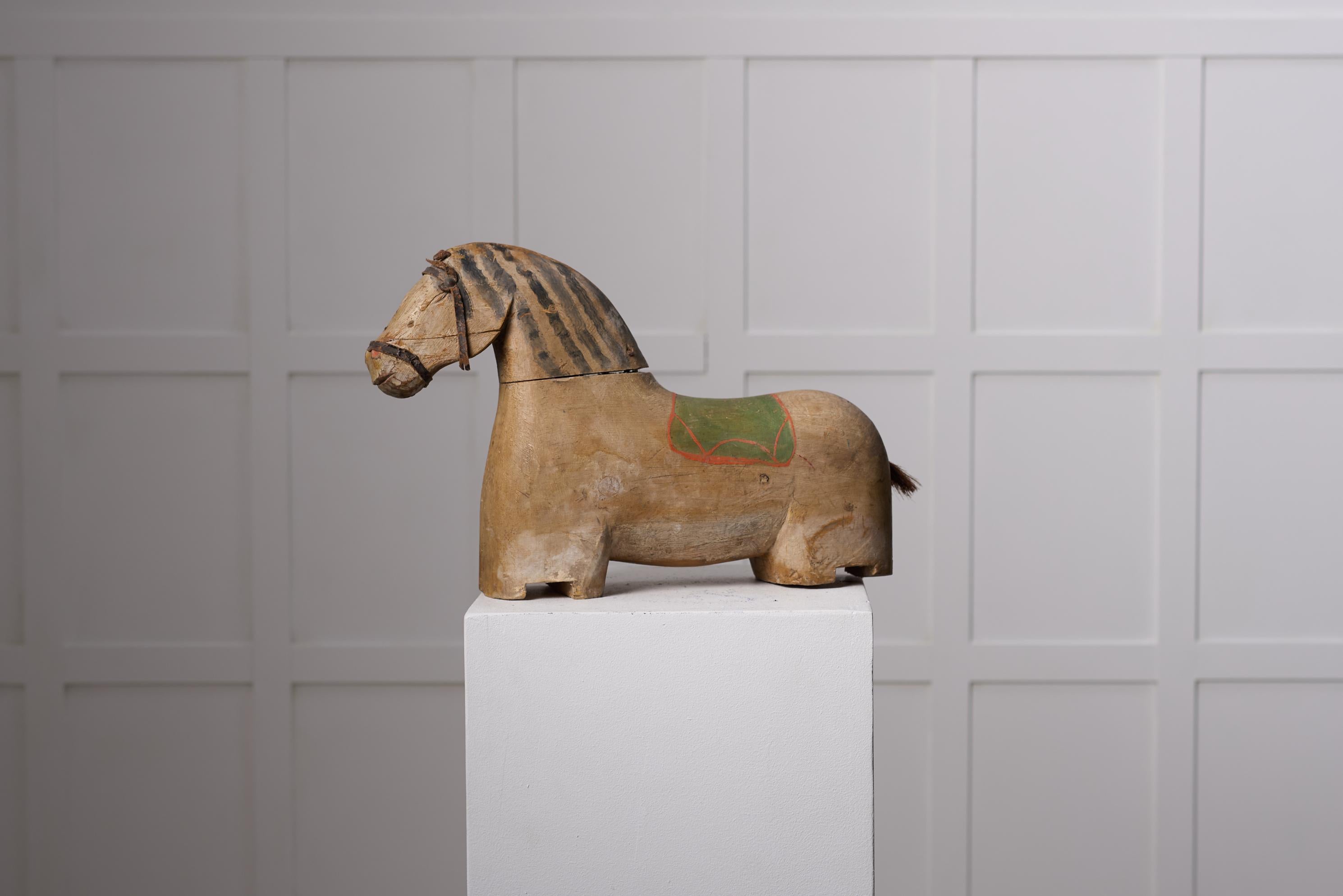 Antique wooden horse sculpture from northern Sweden. The horse is from around 1850 and has a body in pine with original paint. The sculpture is made by hand and a one of a kind piece. Most likely it has been standing on a platform with wheels. The