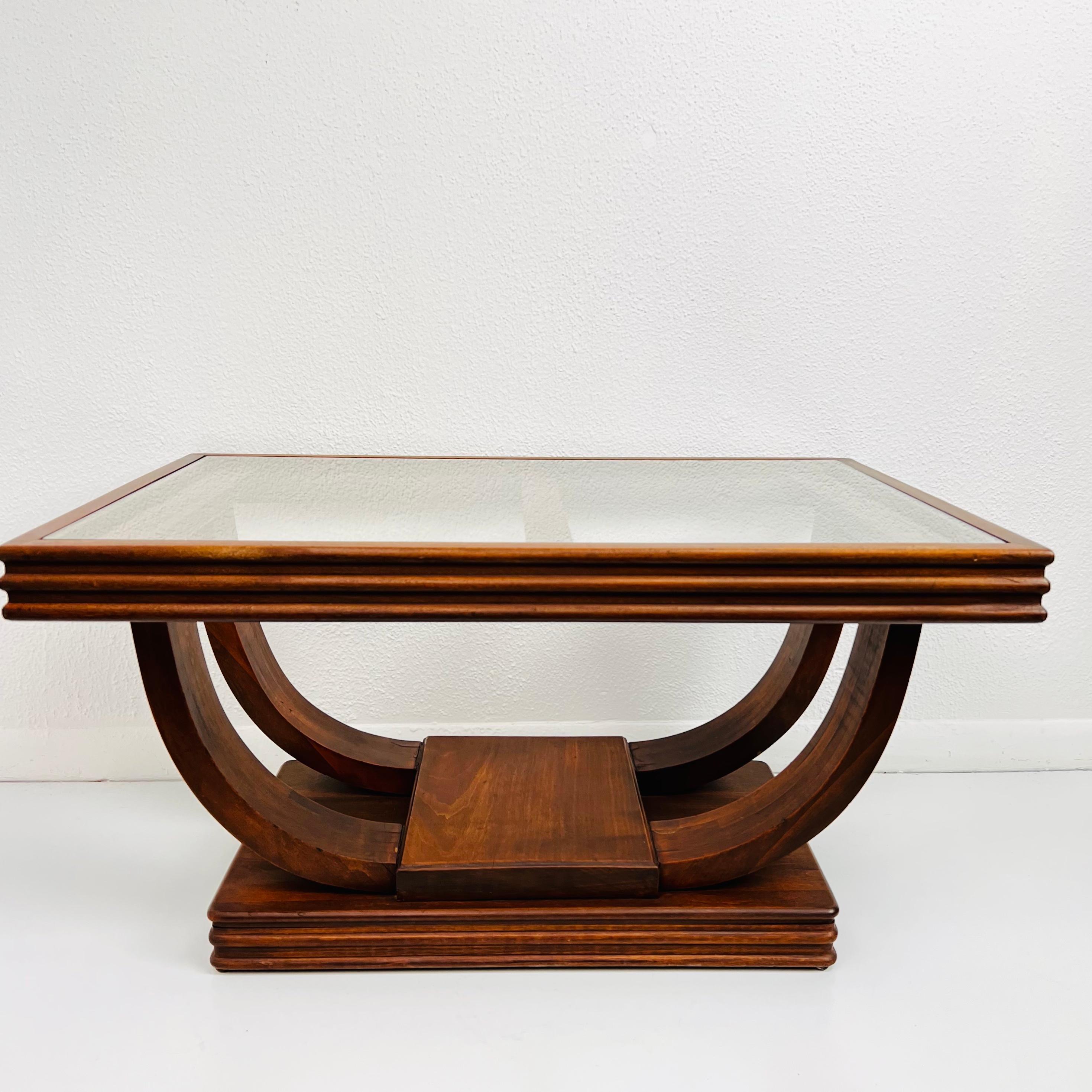 Unique French gondola wood coffee table in the Art Deco style, circa 1930s. Double stretcher U-shaped base supports a Walnut and glass top. Very good antique condition.