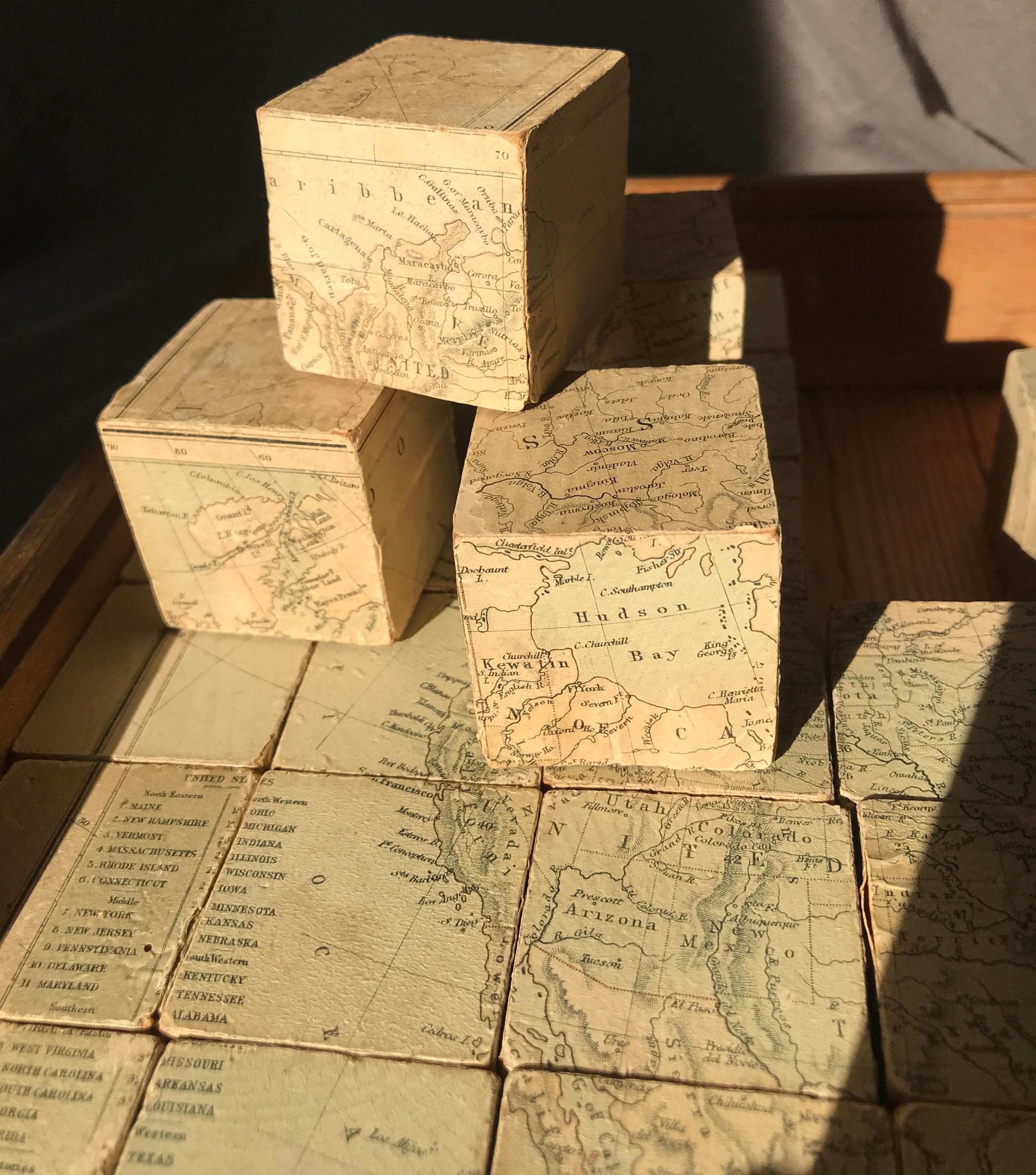 Antique wood block map puzzle. Unusual English six sided block puzzle consisting of 42 wood cubes with each side making up one of six puzzles comprising 1890s maps of Europe, England and Wales, North America, South America, Africa and Asia. George