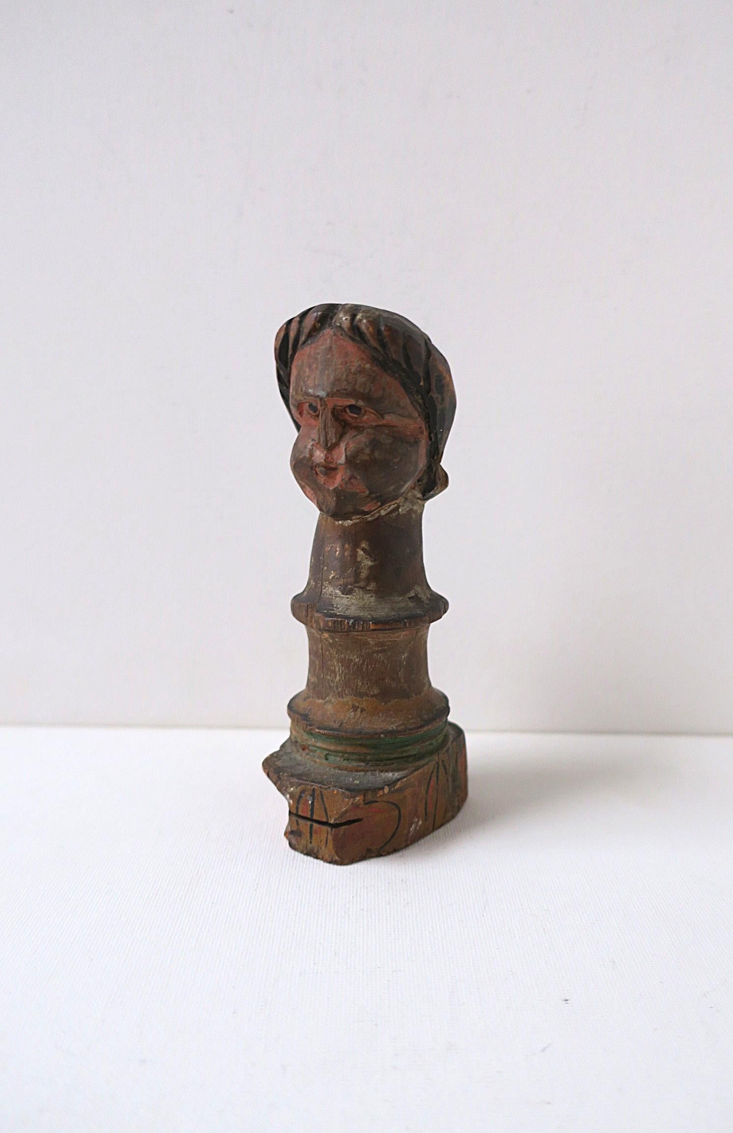 An antique wood figurative head bust sculpture, circa late-19th century to early-20th century. Piece is hand-carved and decorated (polychromed.) Piece may have been from a game, ornamentation from an amusement ride, etc., unknown. 