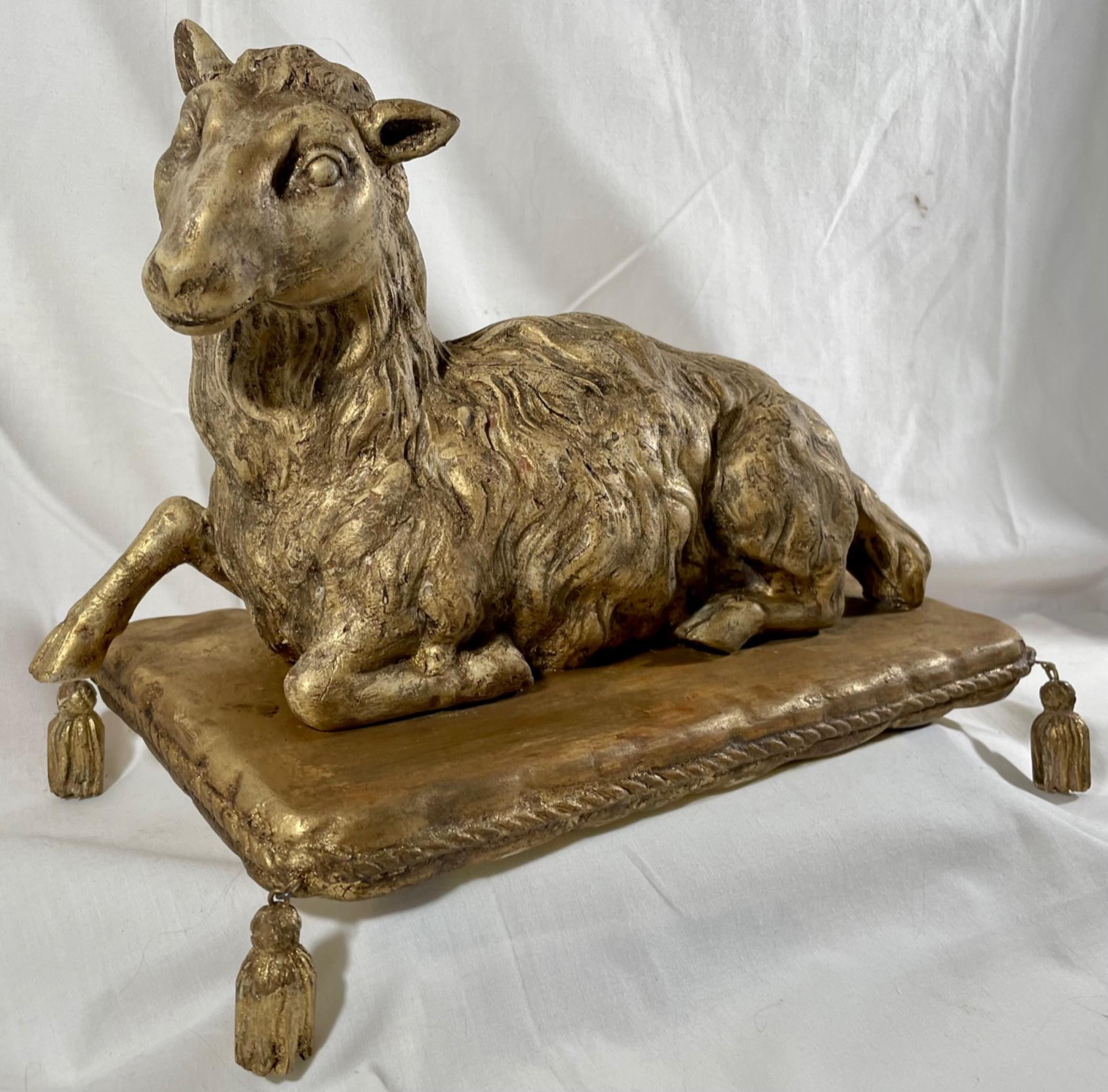 Antique wood carved Agnus Dei paschal lamb on Giltwood Pillow.

Rare antique wood carved Agnus Dei Paschal lamb on giltwood pillow. The beautiful realistically hand carved 19th century gilded wooden lamb is of perfect proportions and in a recumbent