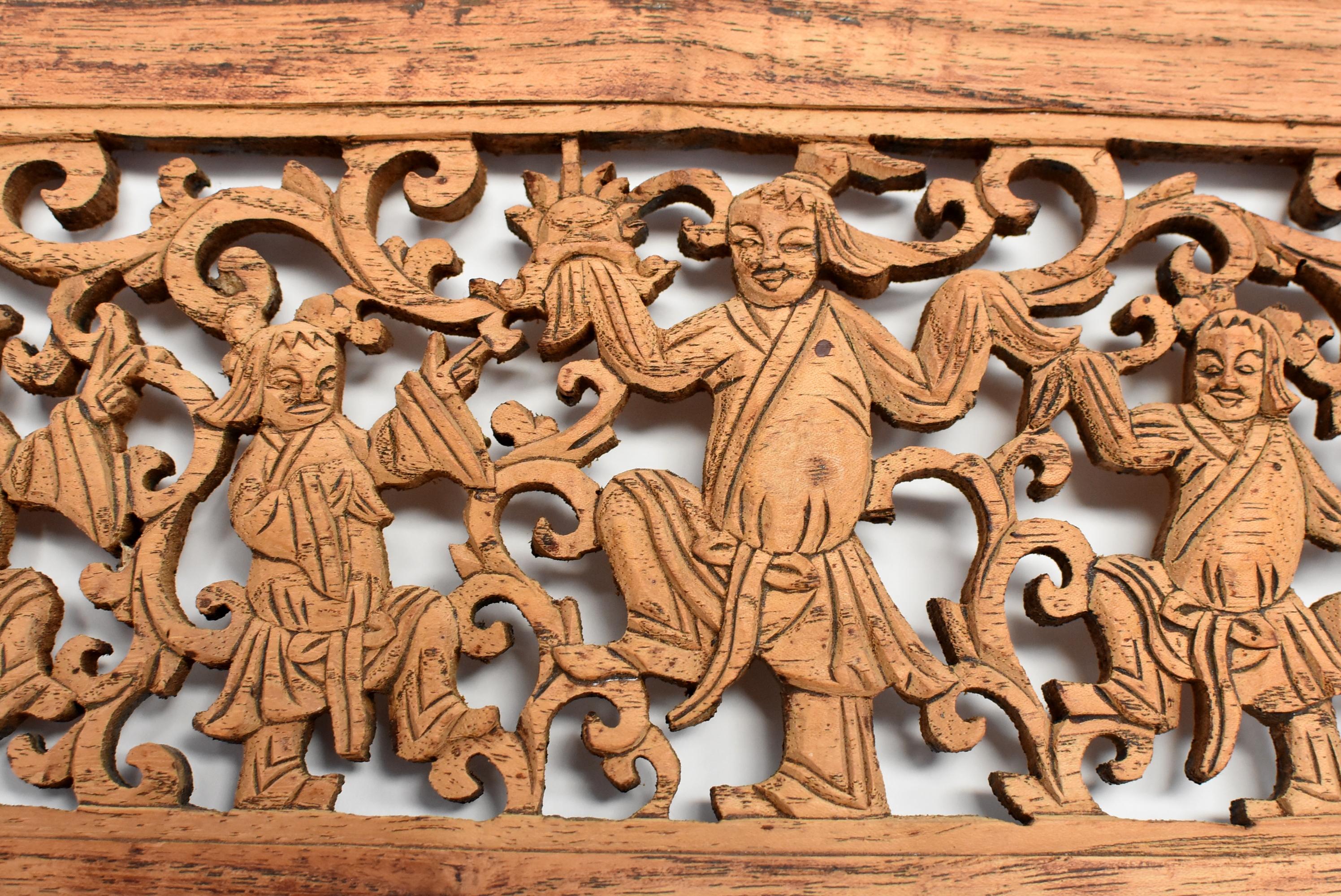 A wonderful 19th century wood carving featuring five men in a tribal dance. Pierced carving adds airiness. Continuous scrolls match the festivity theme. Vivid expressions.