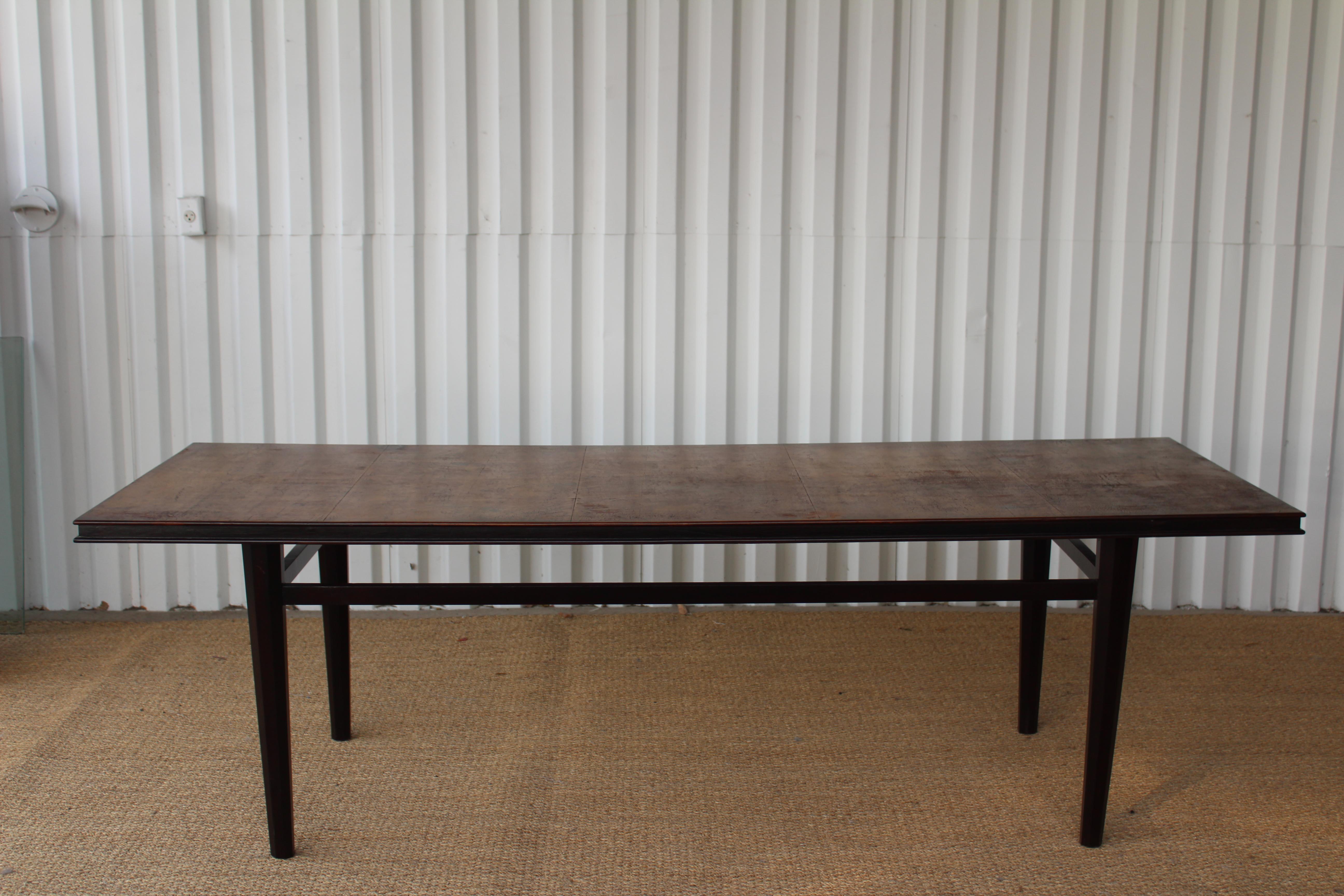 Vintage 1930s dining table. Walnut base with a walnut trim top and veneered top. The table base has been refinished. The top has been repaired and refinished while retaining patina.