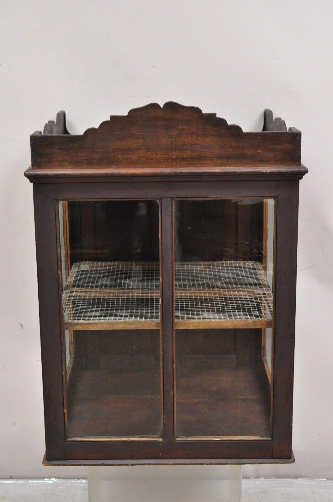 Antique Pine Wood & Glass Counter Top Display County Store Pie Safe Display Cabinet. Item featured is a nice larger size, rear entry with 2 swing doors and latch, single interior chicken wire shelf, glass display on 3 sides, very nice antique item.