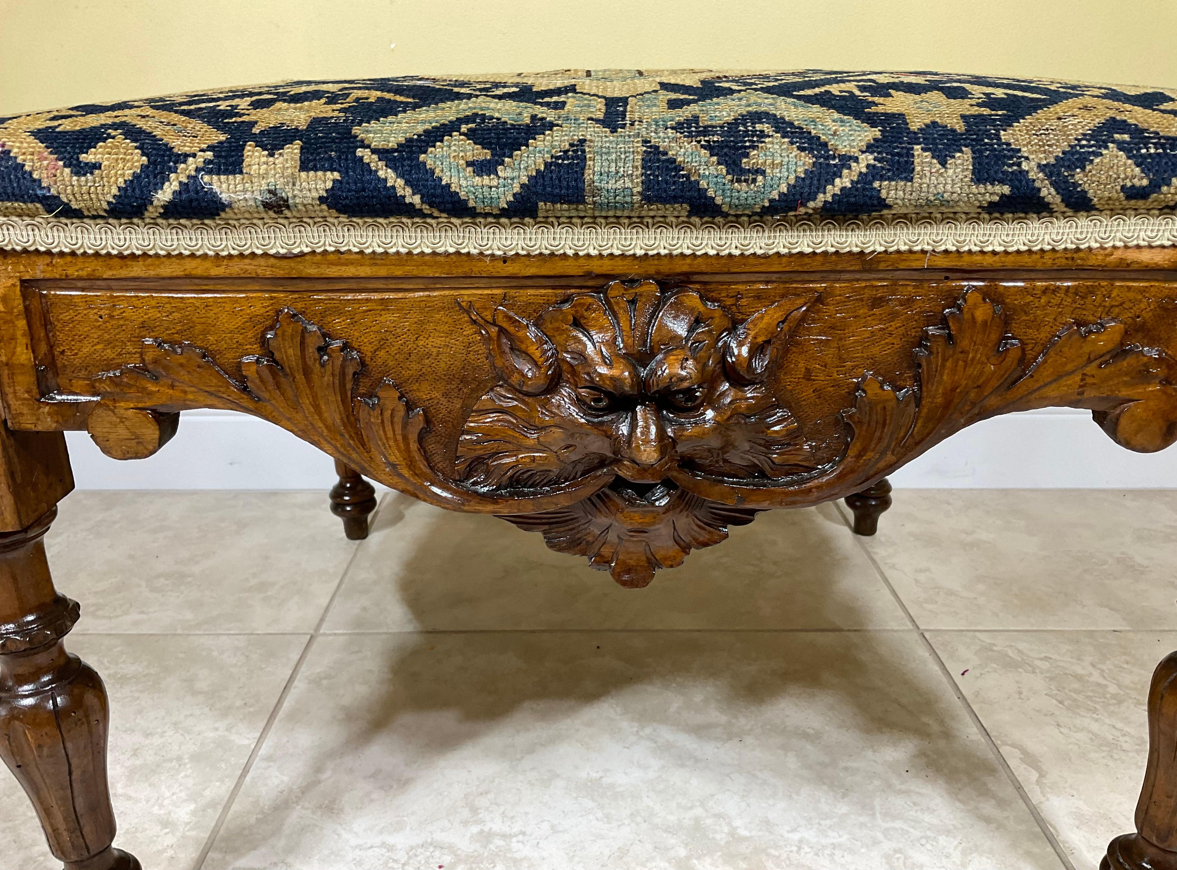 Beautifully hand carved Antiqe piece professionally restored , exceptional vivid carving with one side Mythological face , upholstered with exceptional antique Kazak rug with geometric patterns. Great functions could use as low table , low sit ,or