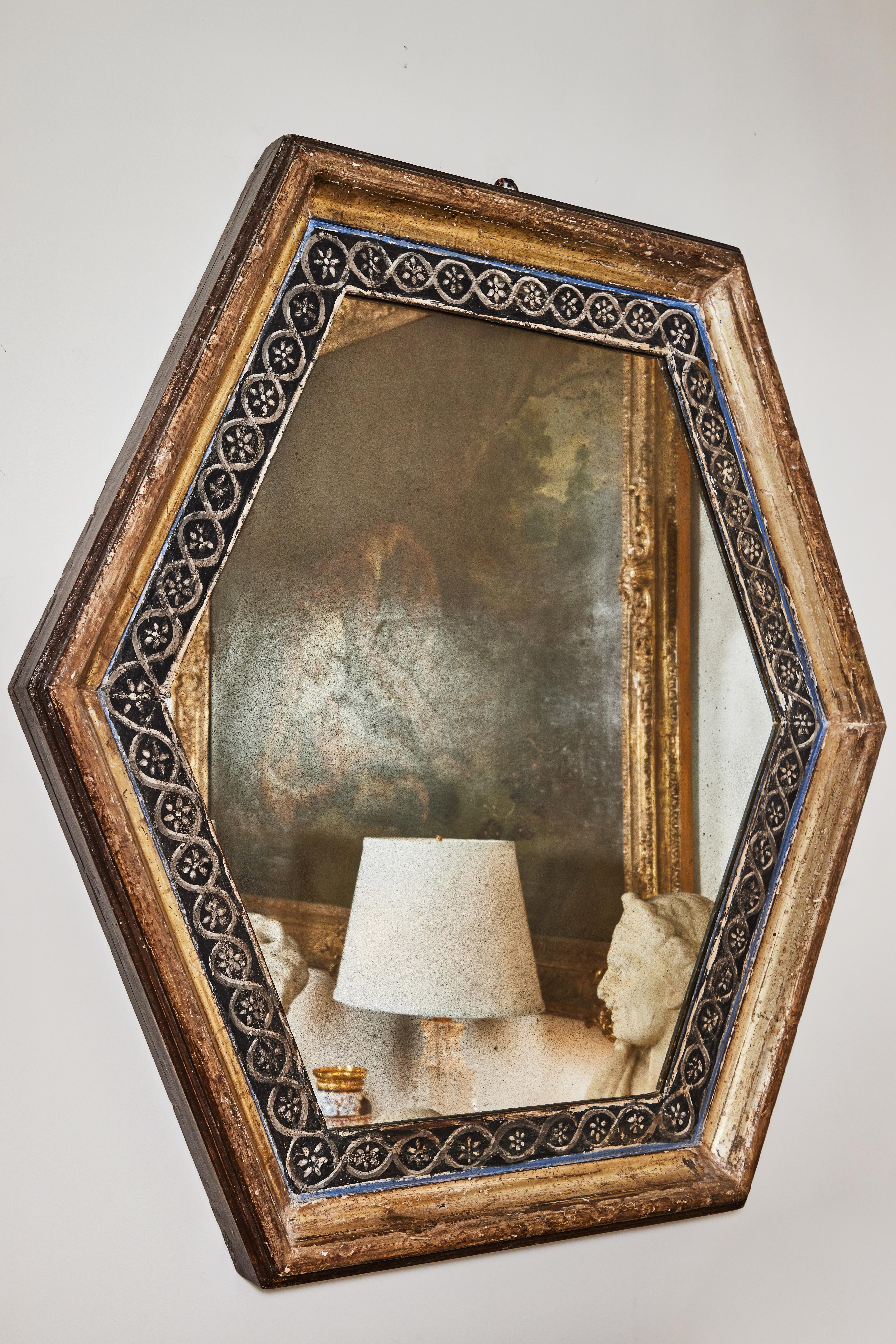 Striking pair of large, gessoed, 24-karat gold water gilded hexagonal, Tuscan frames inset with newer antiqued glass. Each with a stunning, hand painted, inner band of ebonized wood.
