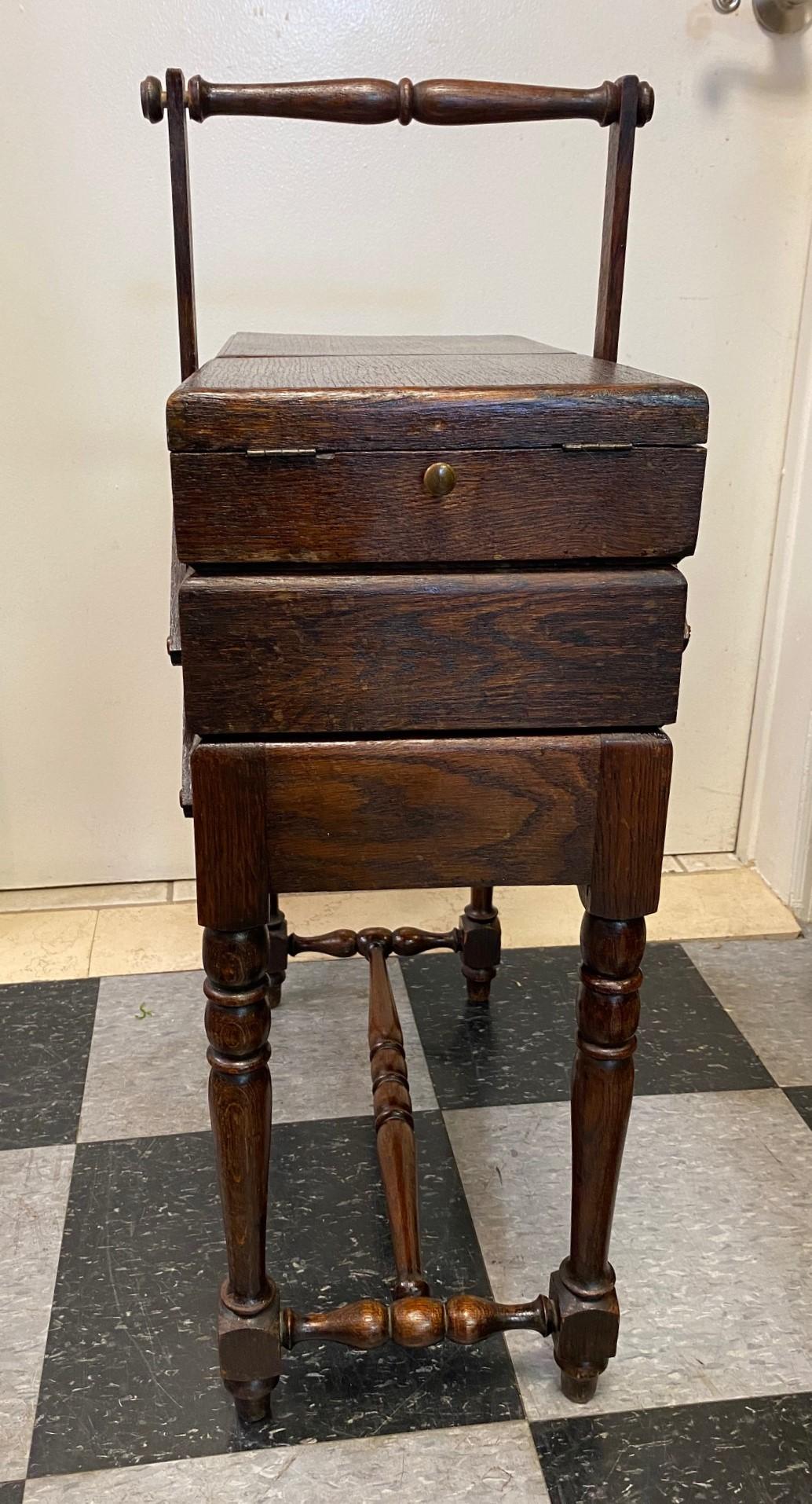 Antique wood sewing cart that opens from the top in two compartments and also opens up further to reveal lots of storage on both sides. Accordion style. Very functional and can be used to store jewelry and even other craft materials. Great
