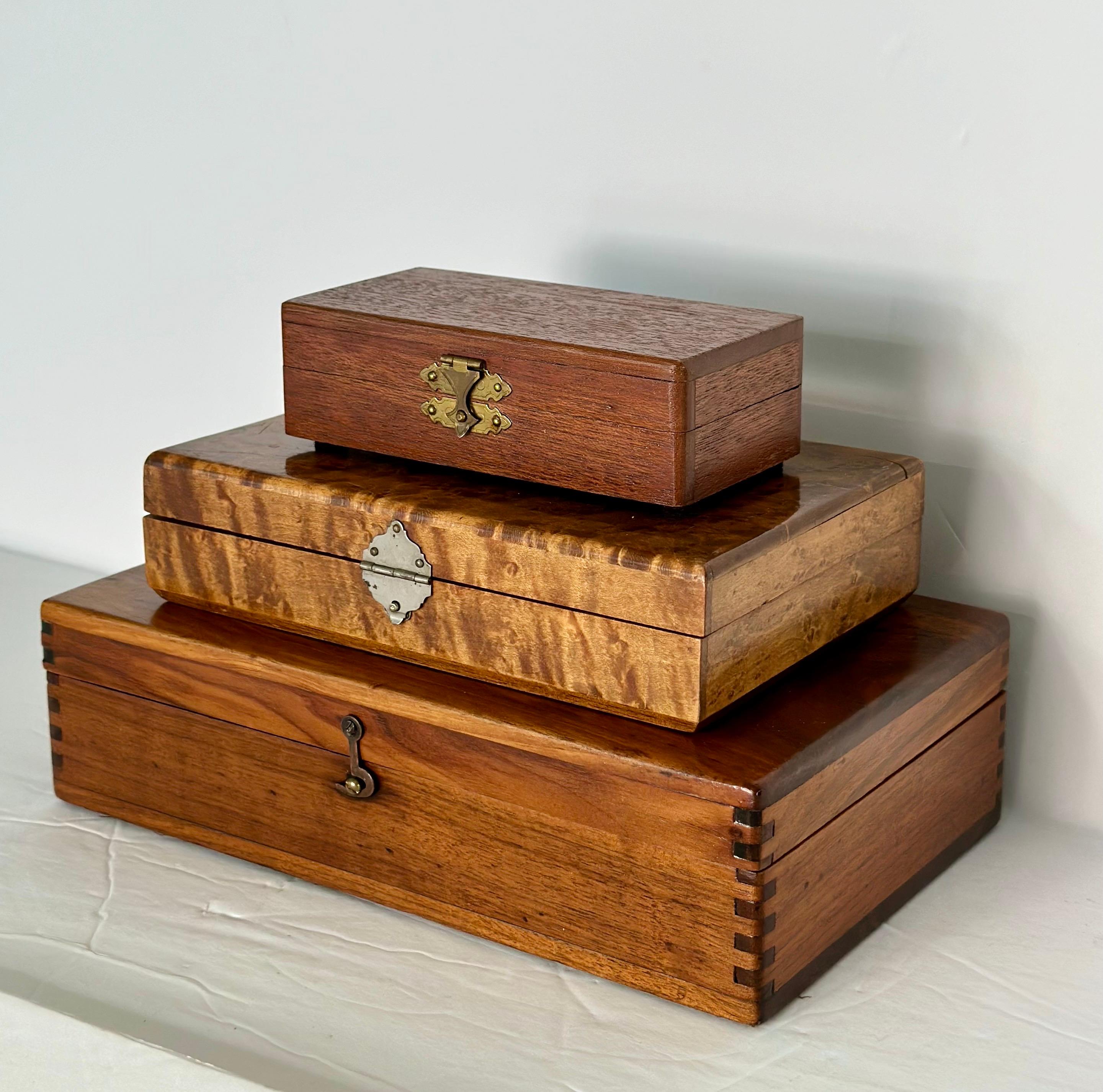 We are very pleased to present a charming set of three antique boxes, each meticulously crafted from different wood species.  This selection of woods provides a stunning contrast in color, texture, and grain variation, enhancing the visual appeal