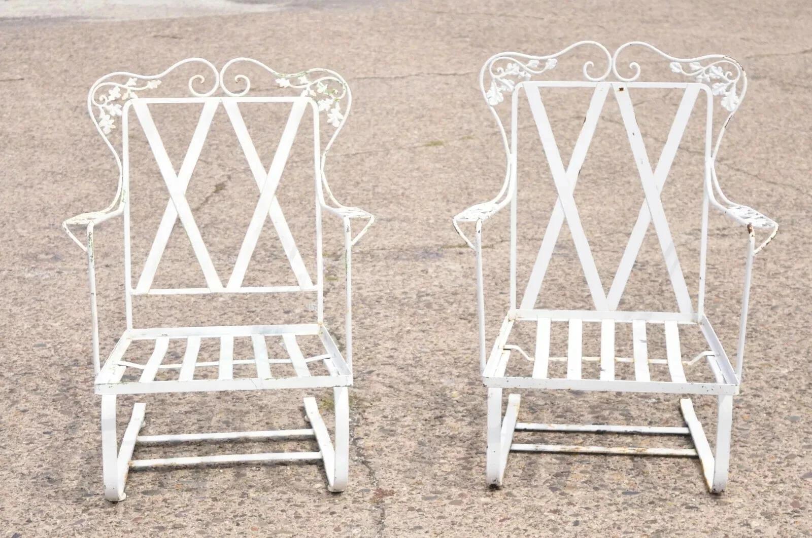 Antique Woodard Orleans Pattern Wrought Iron Patio Bouncer Lounge Chair - His and Hers Pair. Item features his and her frames (one chair slightly bigger), classic Orleans pattern, wrought iron construction, original label. Circa Mid 20th Century.