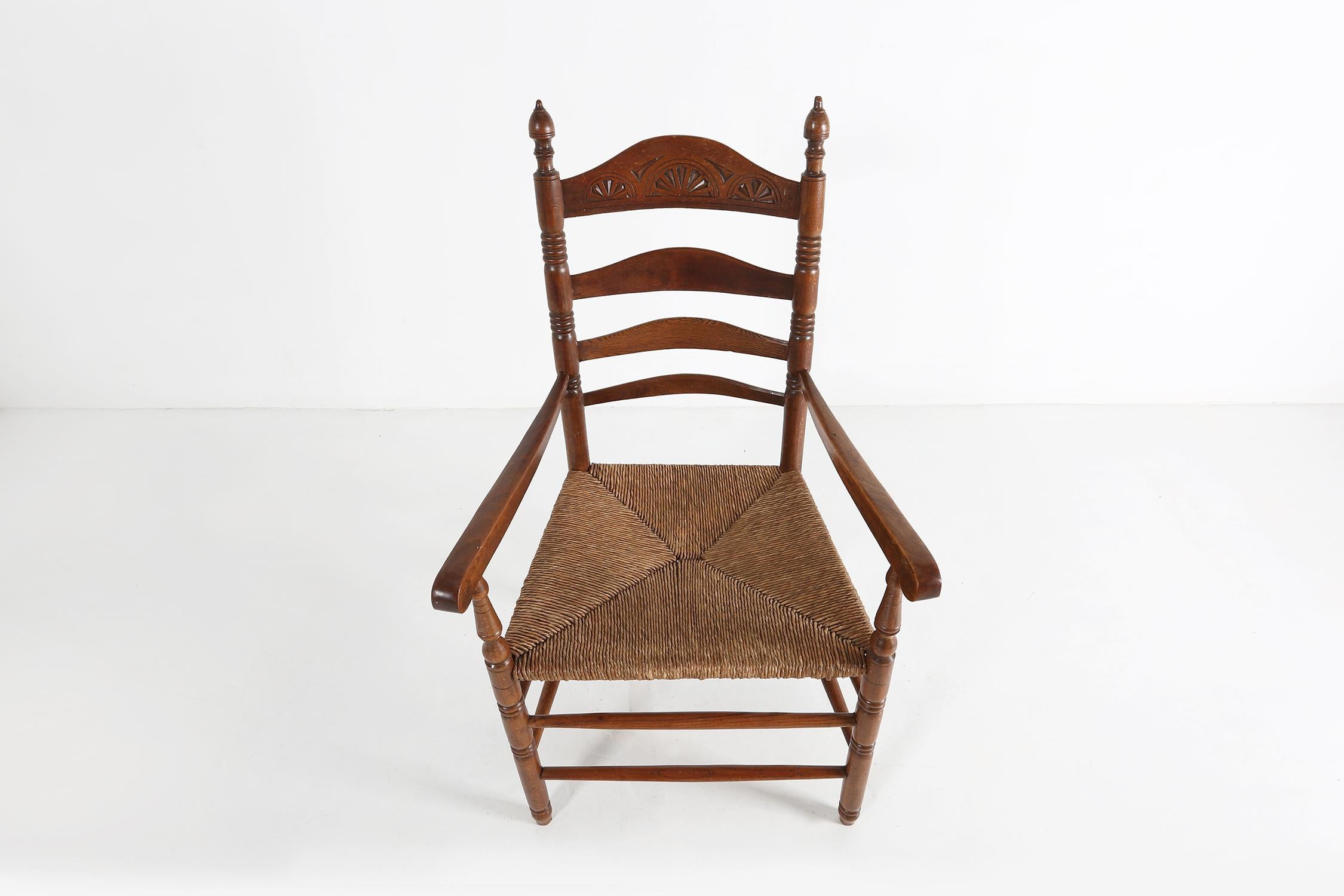 France / 1900 / chair / wood, cane / Romantic / Antique / Rustic  

French antique armchair in solid wood crafted in France around 1900. This rustic chair has nice geometric carvings in the ladder back, turned legs and a cane seat.  

The charming