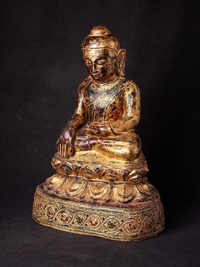 Material: wood
59,8 cm high 
43,2 cm wide and 30 cm deep
Weight: 8.65 kgs
Gilded with 24 krt. gold
Ava style
Bhumisparsha mudra
Originating from Burma
17th century
Very special !!.
 