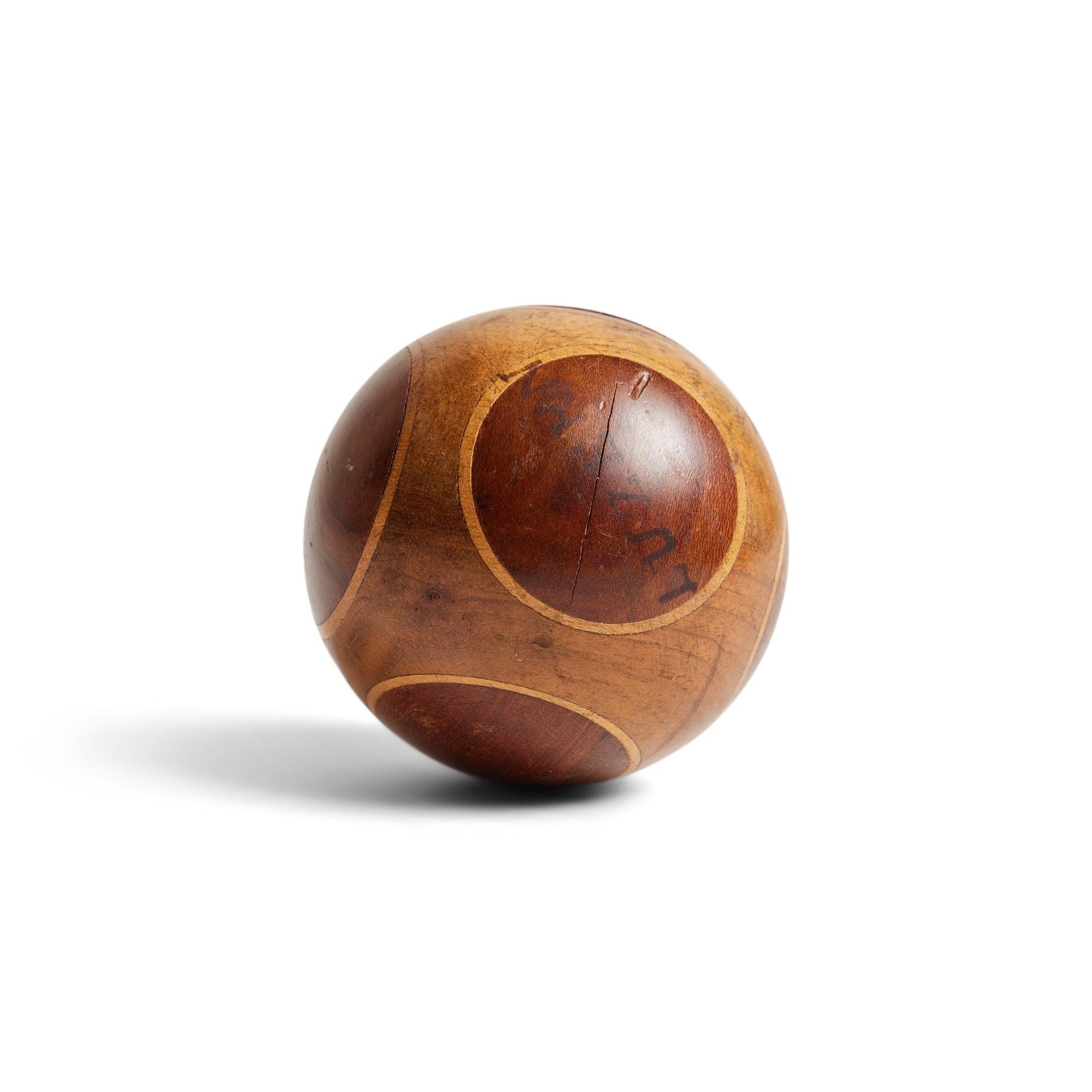 An antique ball made with three woods.