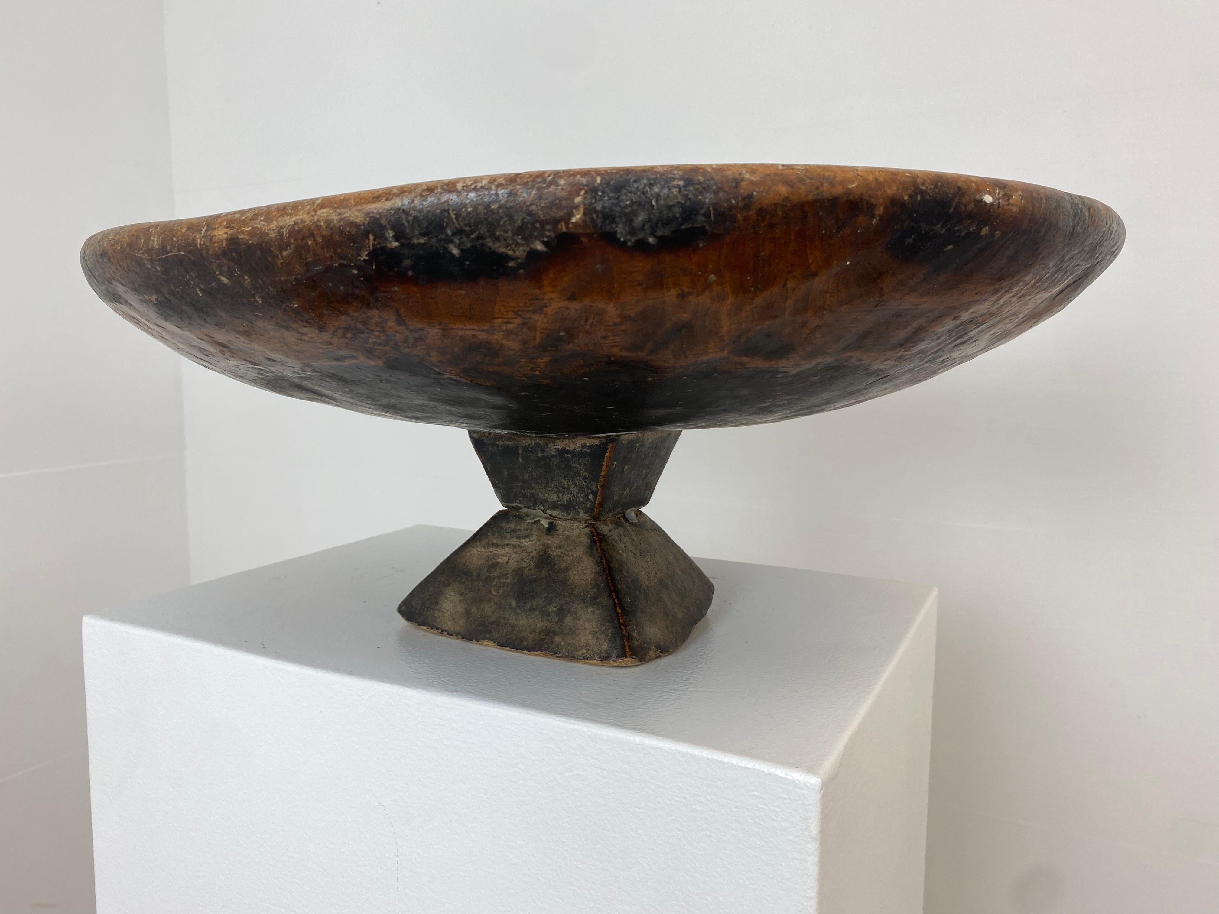 A large, antique Wooden Tazza From the South Of Morocco from around 1920,
superb old patina of the Wood and great, old Shine,
the tazza stands on a fine square foot,
very decorative item to be used for different purposes