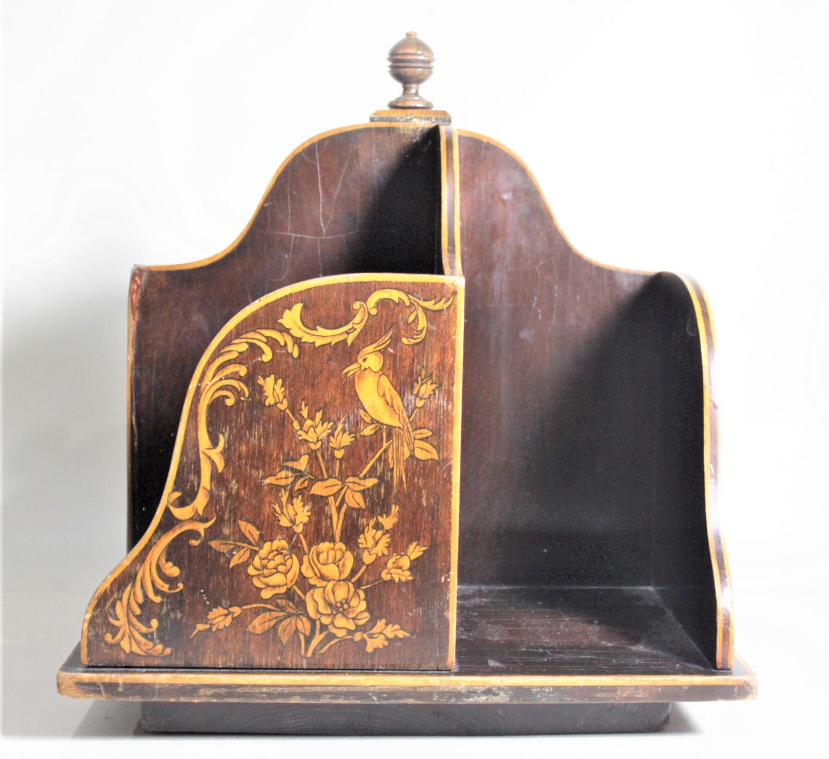 This antique desk top sized wooden book mill or rotating bookcase is presumed to have been made in England in circa 1880 in the period Victorian style. The sides of the mill have nice serpentine lines with gold accents. The side panels each have a