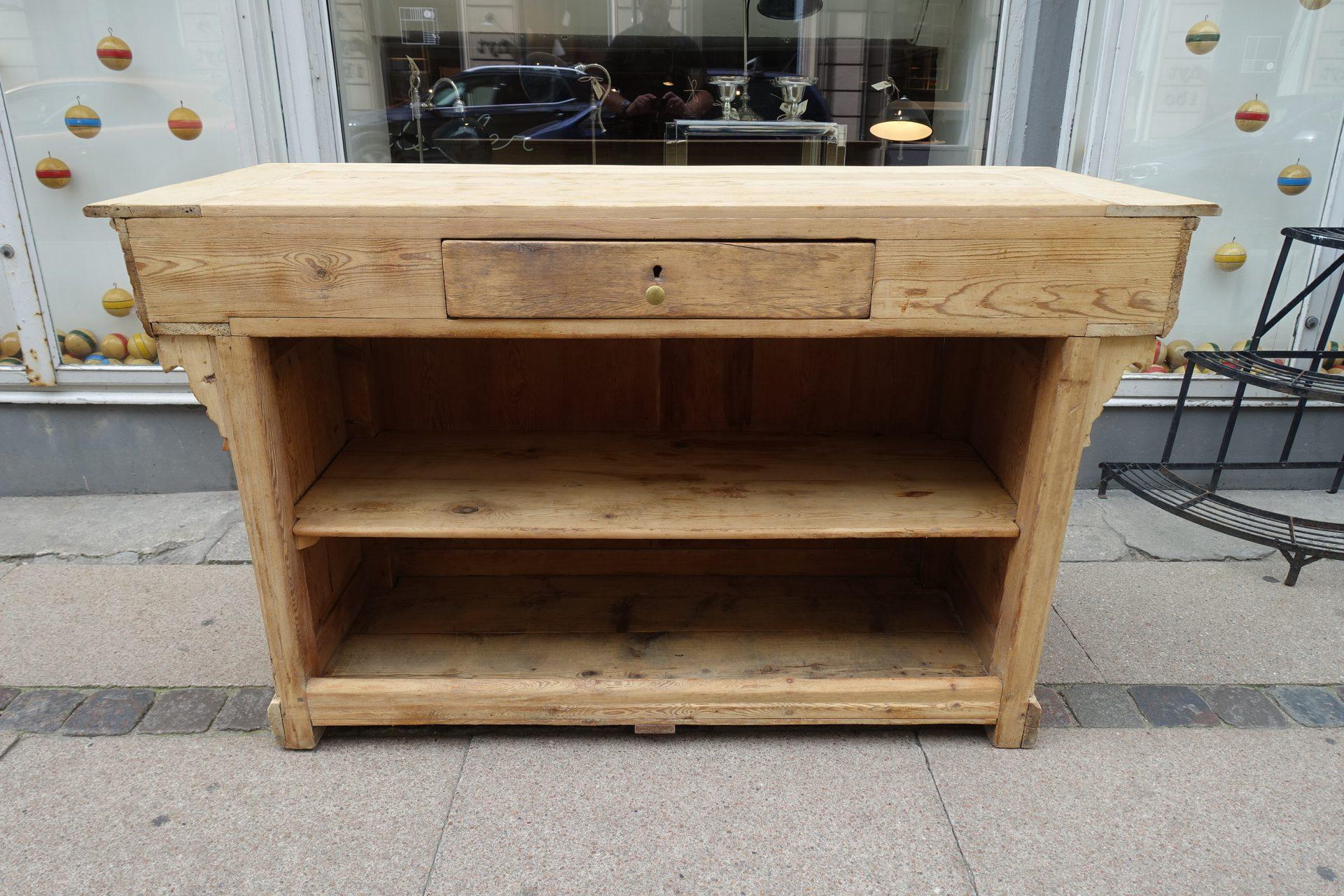 Gorgeous antique shop counter, in lovely pale pine. Originally from a gentlemen’s attire boutique in Montpellier. A gorgeous centrepiece for a showroom. Behind, it has and open compartment / cubby space, and shelving, as well as a drawer for the