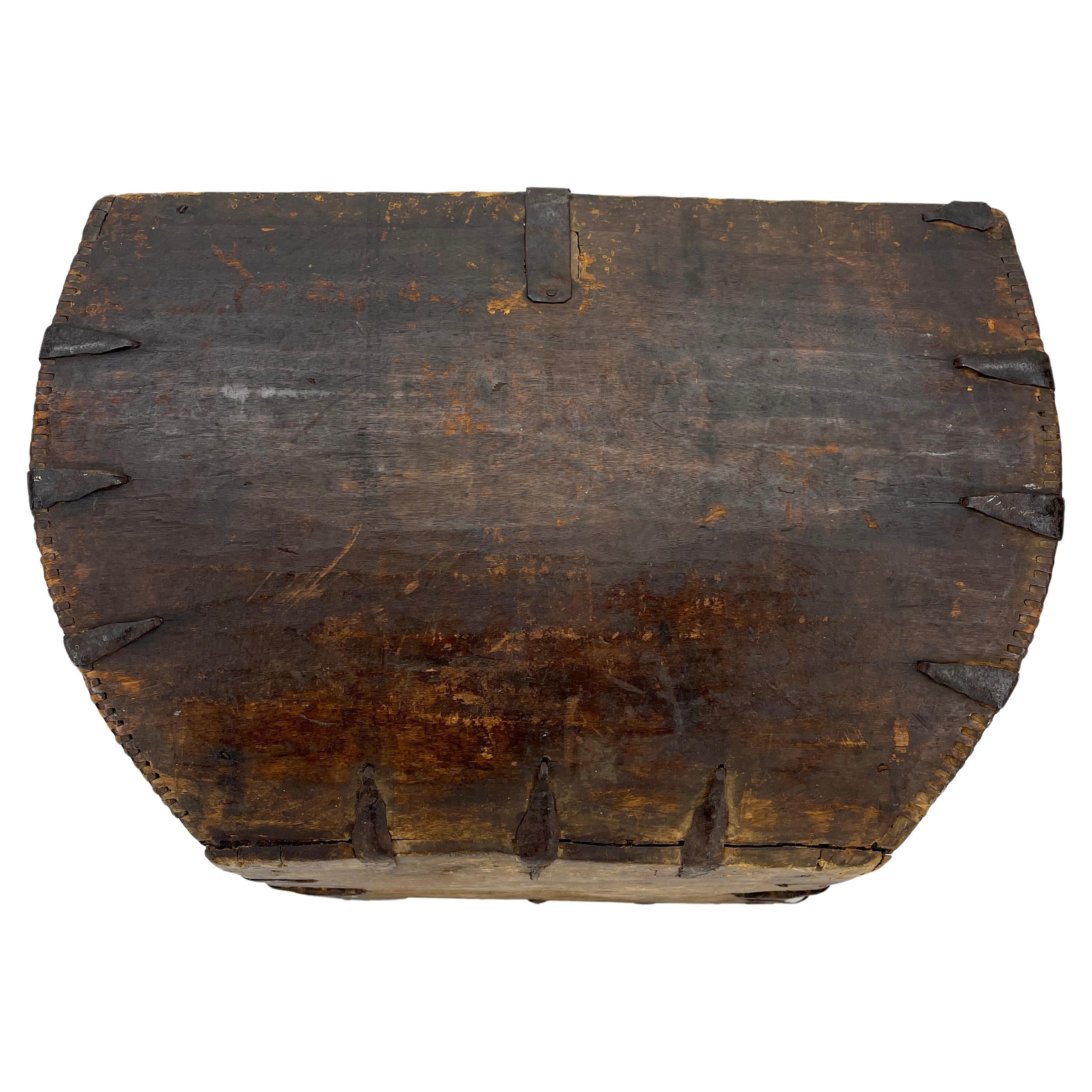 Antique wooden box with center handle. This vintage box is sturdy, full of character and bears a fantastic patina from age. With the center handle it can easily be used for carrying wood or just as an interesting decor object in the home.