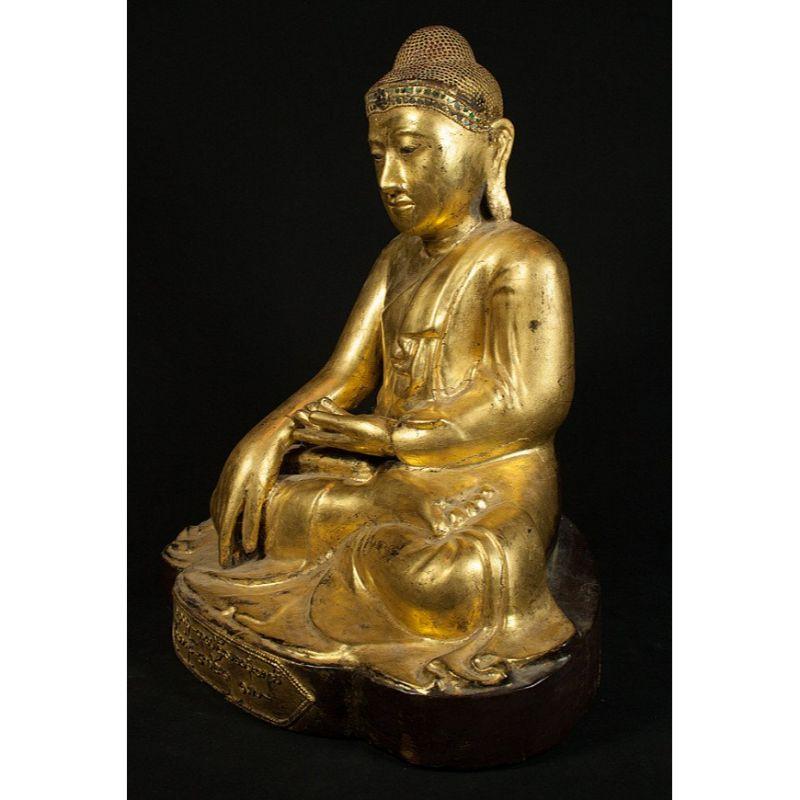 Material: wood
44,5 cm high 
39 cm wide and 28 cm deep
Weight: 7.3 kgs
Gilded with 24 krt. gold
Mandalay style
Bhumisparsha mudra
Originating from Burma
19th century
The statue has probably been regilded in the middle of the 20th