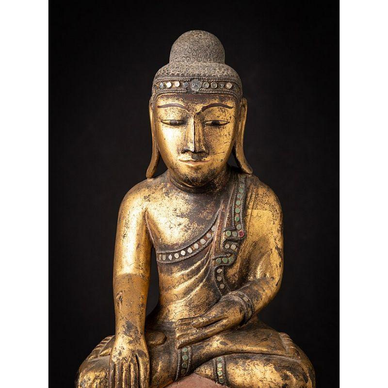Material: wood
66,2 cm high 
21 cm wide and 15 cm deep
Weight: 2.184 kgs
Gilded with 24 krt. gold
Shan (Tai Yai) style
Bhumisparsha mudra
Originating from Burma
18th century

