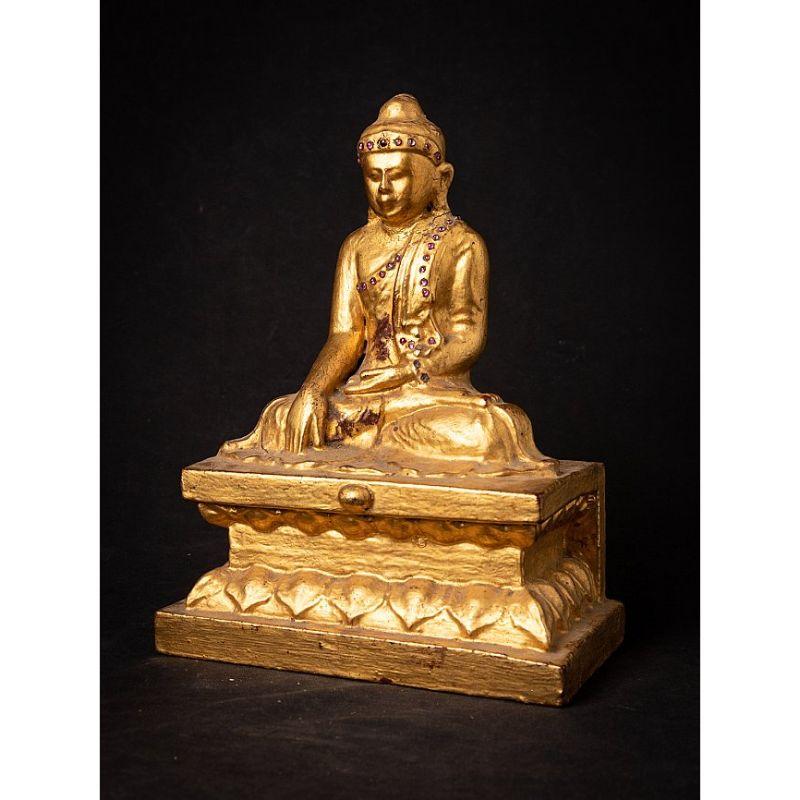 Material: madera
30,7 cm de altura 
22,7 cm de ancho y 13,8 cm de fondo
Peso: 2.548 kg
Dorado con oro de 24 krt.
Estilo Mandalay
Bhumisparsha mudra
Originaria de Birmania
siglo XIX
Con un espacio hueco en la parte posterior de la base,