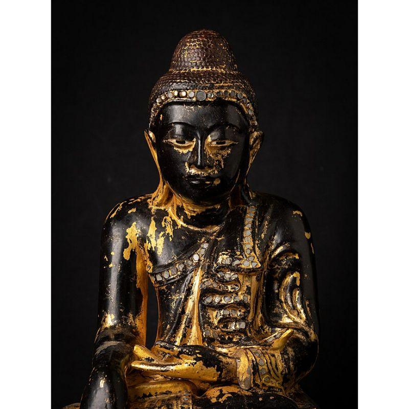 Material: wood
41,8 cm high 
31,5 cm wide and 23,7 cm deep
Weight: 5.340 kgs
With traces of 24 krt. gilding
Mandalay style
Bhumisparsha mudra
Originating from Burma
19th century
With inlayed eyes

