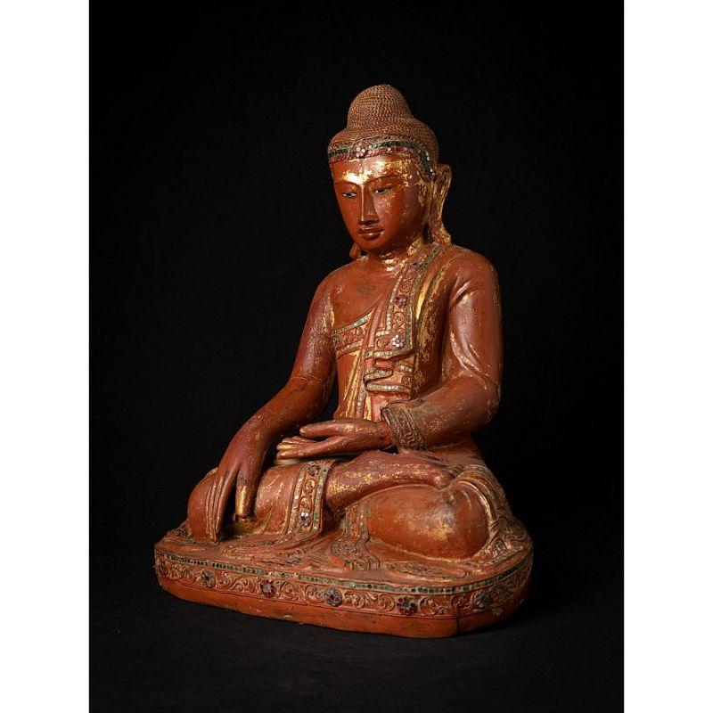 Material: wood
48 cm high 
36,5 cm wide and 27,5 cm deep
Weight: 7.012 kgs
With traces of 24 krt. gold
Mandalay style
Bhumisparsha mudra
Originating from Burma
19th century
With inlayed eyes

