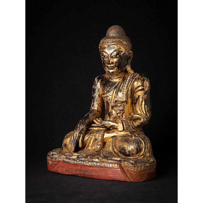 Material: wood
40 cm high 
31 cm wide and 23,2 cm deep
Weight: 4.55 kgs
Gilded with 24 krt. gold
Mandalay style
Bhumisparsha mudra
Originating from Burma
19th century
With inlayed eyes

