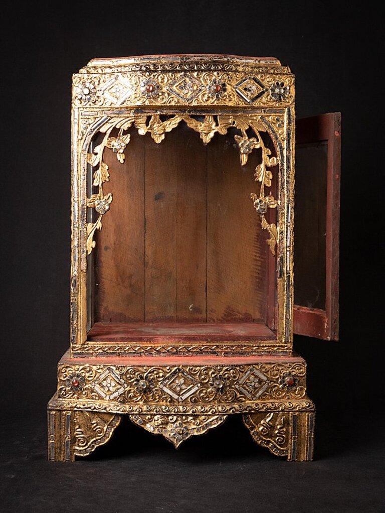 Material: wood
60,8 cm high 
39,1 cm wide and 28,5 cm deep
Weight: 7.246 kgs
Gilded with 24 krt. gold
Mandalay style
Originating from Burma
19th century.
 